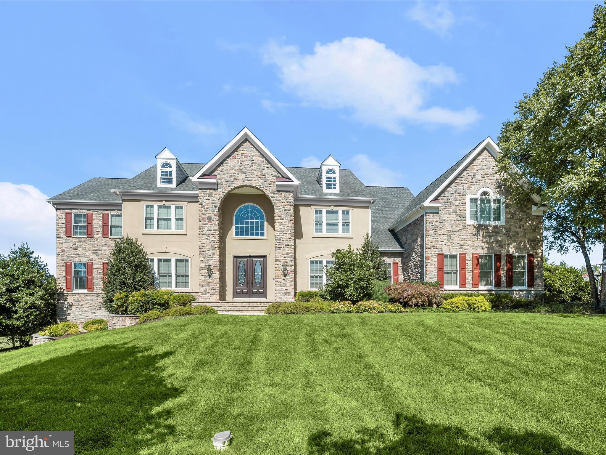 Welcome to 3918 Clarks Meadow Drive, a custom-built Douglas Home in the prestigious Clarks Meadow community. This thoughtfully designed estate is richly appointed with exceptional details including lit tray ceilings, elegant millwork, stately columns, custom closet organizers, and a gracious open floor plan. A highlight of this home is the spectacular outdoor living space, set on a lush 1.13-acre featuring an inground pool, expansive custom patios, a deck, and professionally landscaped grounds with sweeping views of the countryside.
The grand two-story foyer, with dual curved staircases, is flanked by formal living and dining rooms accented with classic moldings. The living room opens to a light-filled sunroom, while the gourmet kitchen is a chef’s dream, complete with an induction cooktop, double convection wall oven, microwave drawer, Sub-Zero refrigerator, granite countertops, decorative backsplash, soft-close and display cabinetry, a center island with breakfast bar, butler’s pantry with wine fridge, walk-in pantry, and a sunlit breakfast room. A stunning conservatory with rounded walls and access to the deck further enhances the entertaining flow. The two-story great room, anchored by a stacked-stone fireplace, creates a warm and inviting gathering space. A private office with French doors, a full bath, laundry room, and access to the three-car garage complete the main level.
Upstairs, the luxurious primary suite features a sitting room, two walk-in closets, one with attic storage and a spa-inspired bath with dual vanities, a glass-enclosed shower, and a soaking tub. Three additional ensuite bedrooms and a spacious bonus room complete the upper level. The fully finished lower level is designed for leisure and entertainment with a game room and wet bar with wine nook, a media room, exercise room, additional ensuite bedroom with walk-in closet, and abundant storage.
This extraordinary home seamlessly blends elegance and comfort, offering luxurious interiors and resort-style outdoor living in one of the area’s most sought-after communities.