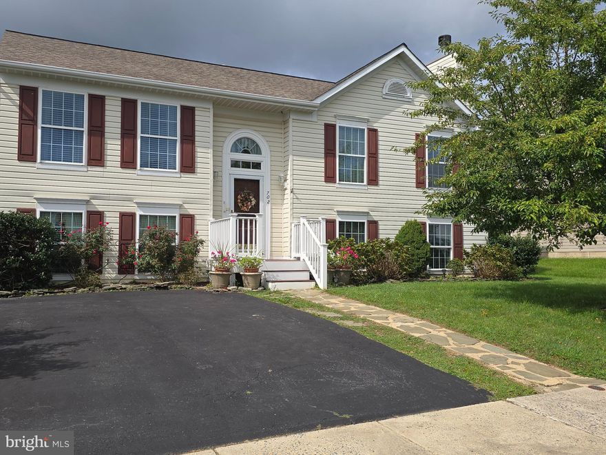 Welcome to this charming detached home tucked away on a quiet street in the desirable Lohr's Orchard neighborhood. With 4 bedrooms and 2 full baths, this residence offers generous living space and tons of natural light. Step into a bright and airy layout featuring a large living room perfect for relaxing or hosting guests. The expansive dining room flows seamlessly into the kitchen and opens to the backyard through double patio slider doors, inviting natural light and easy access to outdoor gatherings. Enjoy cozy evenings in the family room with a fireplace, ideal for creating warm memories year-round. The home also boasts ample storage throughout, making organization effortless. Outside, the large backyard is a private oasis with plenty of room to play, garden, or unwind. The oversized deck with retractable awning is perfect for entertaining, dining, morning coffee, or simply soaking up the sun. Updates include washer/dryer 2017, water heater 2025, roof approx 7 years young, fridge 2020, AC/furnace approx 9 years young.  Whether you're looking for space, comfort, or a peaceful setting, this home checks all the boxes. All it needs are your finishing touches and design choices to make this house your home!