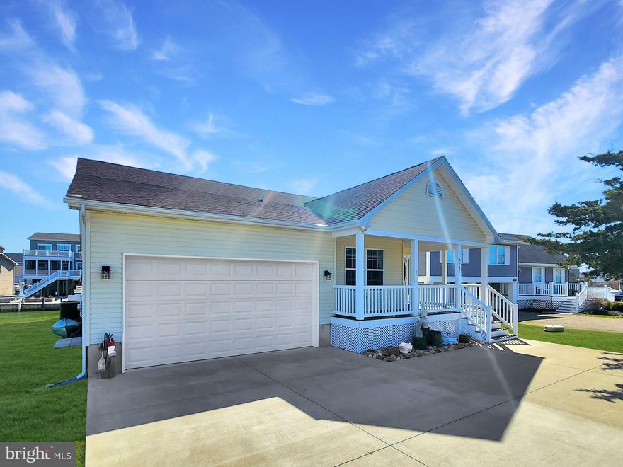 Better than Brand New and offered FULLY FURNISHED!!! This immaculate home, situated on 78 feet of direct waterfront, was completed in 2021 and has been impeccably decorated and maintained. As you arrive, you will notice the concrete driveway and maintenance free composite decking. Once inside, admire the gorgeous  Luxury Vinyl Plank flooring, cathedral ceilings, gas fireplace and abundant natural light as you take in both canal and bay views throughout the spacious open floor plan. This well designed home features 3 bedrooms and 3 full bathrooms, a beautifully designed kitchen with ample soft close cabinets, quartz counter tops, all stainless appliances, tankless hot water, and a pantry. The relaxing four seasons room boasts views all the way to Chincoteague Island. The boat lift has not yet been used.  Located in amenity rich Captains Cove which features a Golf Course, 2 outdoor pools and 1 indoor pool, tennis, basketball and pickleball courts, playground, dog park, boat ramp, fitness room, and Marina Club Restaurant. Waterfront living on a beautifully situated elevated property . This beautiful home is offered furnished and turn-key. Wall art, tools, recreational items all convey. Show up and get busy enjoying the good life on the Chincoteague Bay. Home is not in a flood zone according to FEMA Flood Map.