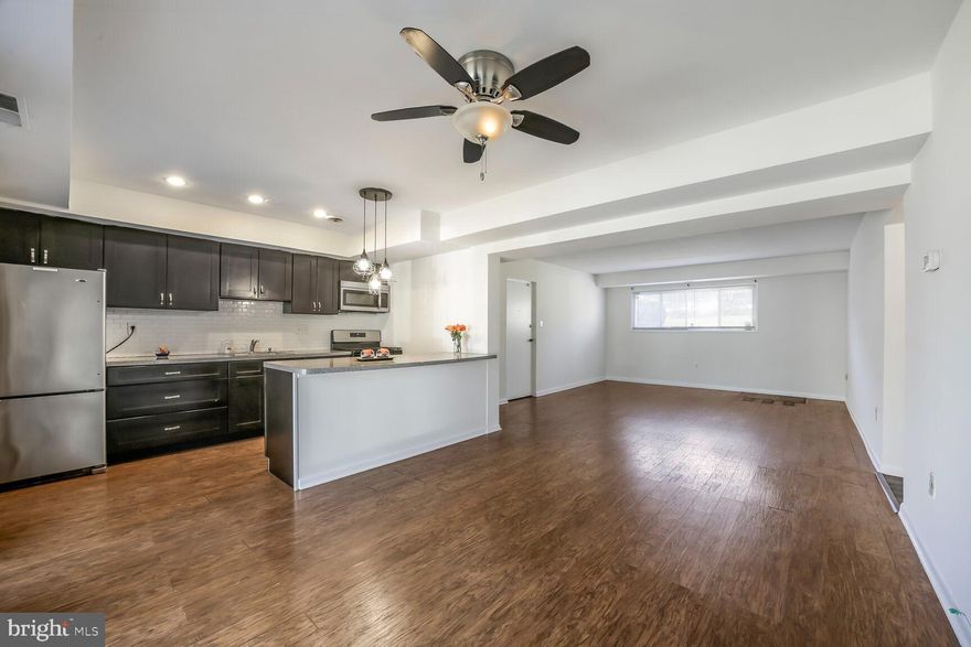 Located in the center of the Carrollan Garden Condominiums, this condo is just a few steps down from the building’s front entrance. Step inside to a spacious open floor plan filled with natural light. To your left is the living room, and to your right is a large kitchen featuring an island with space for bar stools, ample cabinet storage, and generous counter space. A large closet next to the kitchen provides additional pantry and storage space. Beyond the kitchen, you’ll find a versatile area that can serve as a formal dining space or family room, situated next to the sliding door leading to the patio and utility closet. Down the hallway are three bedrooms and 1.5 baths. To your right is the primary bedroom, complete with a walk-in closet and an en-suite half bath. Across the hall is the second bedroom, featuring a large closet and window, followed by the third bedroom and a full bath with a tub. This condo feels more like a house, offering abundant natural light, a well-designed layout, and ample space. Enjoy life in an excellent condo community with beautifully maintained lawns, a pool, a playground, and open spaces. The location is unbeatable—steps from a bus stop, just a few blocks from shopping centers, and conveniently near major highways and roads leading to D.C. Investors are welcome. Reach out to listing agent for lender recommendation for this condo community.