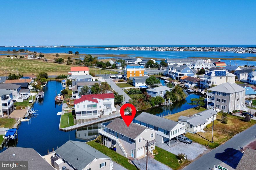 BEACH & BOATERS DREAM - This charming furnished canal front Coastal Cottage is ready for you …..complete with Boat dock right at your backdoor!  If you’ve dreamed of owning a beach house with the added benefit of access to the Bay & Ocean….this is it! Spacious 4 Bedroom 3 Bath home is less than 1 mile to Ocean surf & the vibrant Beach-town of Fenwick with great shopping & restaurants.  Enjoy tranquil views of the water, sunrise & sunset from your glass-lined Sunroom on the Main Level. Bright Living Room with hardwood floors, spacious kitchen with Breakfast bar, 2 Bedrooms, Den or 3rd Bedroom plus 2 full Baths completes the upper level.  The lower level can be a private retreat for your Guests or additional entertaining space, with large Gathering Room, Mini-Kitchen, Bedroom & Full Bath which all lead to the waterfront deck - easily screened or closed in for additional space.  This home also features Garage, Outside Shower, new/newer HVAC & HWH, all freshly painted - inside & out! Prime location with access to the Big Assawoman Bay & Ocean City Inlet.  Quiet neighborhood - no thru traffic & easy walk to 3 waterfront restaurants or hop on your bike to catch the waves at the beach. Spacious lot with room for games, gardens & lots of parking. Excellent income potential for summer rentals with NO RENTAL RESTRICTIONS - short term rentals are allowed. 
                                                        Plus NO HOA FEES & low Delaware taxes.  
Don’t miss this opportunity!