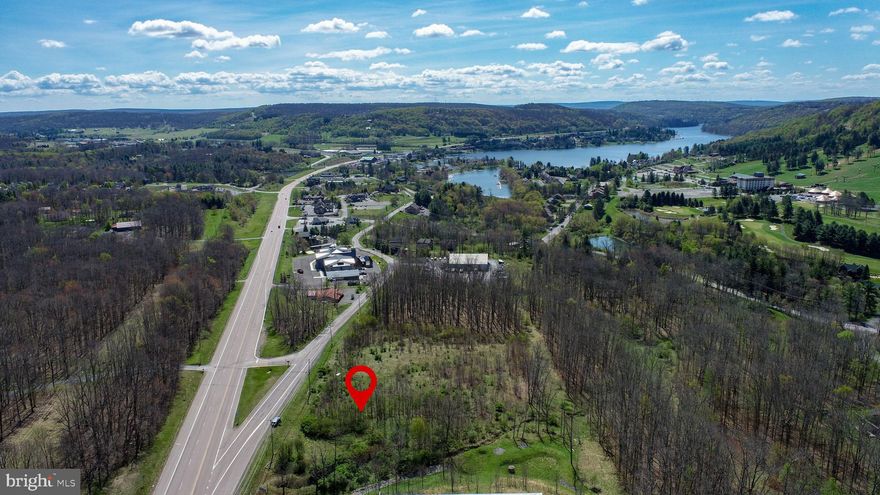 Positioned in the heart of Deep Creek Lake, this 3-acre parcel offers exceptional development potential with Town Center zoning—opening the door to a wide range of commercial opportunities. Boasting over 900 feet of road frontage along Deep Creek Drive, the property provides outstanding visibility and access in a high-traffic corridor. Public water and sewer are available, with one sewer tap already in place for added convenience. Ideally located just minutes from Wisp Resort, the lake, and area amenities, this is a prime opportunity to bring your vision to life in one of Garrett County’s most active and desirable areas.