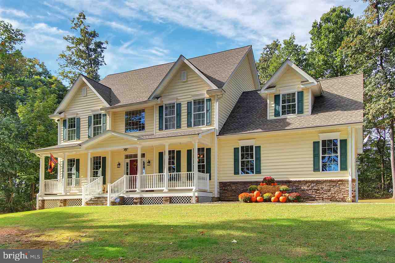Stunningly well appointed custom built colonial on 1 acre lot w/a view. Beautiful kitchen w/ stainless appliances, granite counters, butlers pantry, built in desk, & hickory floors. 4 spacious bedrooms including a beautiful master suite, 2nd floor laundry, a separate study, formal living & dining rooms. Brand new high end custom 20 x 27 composite deck, front porch with a view, 14x28 shed, all at the end of the cul de sac. Amazing Must See Home !