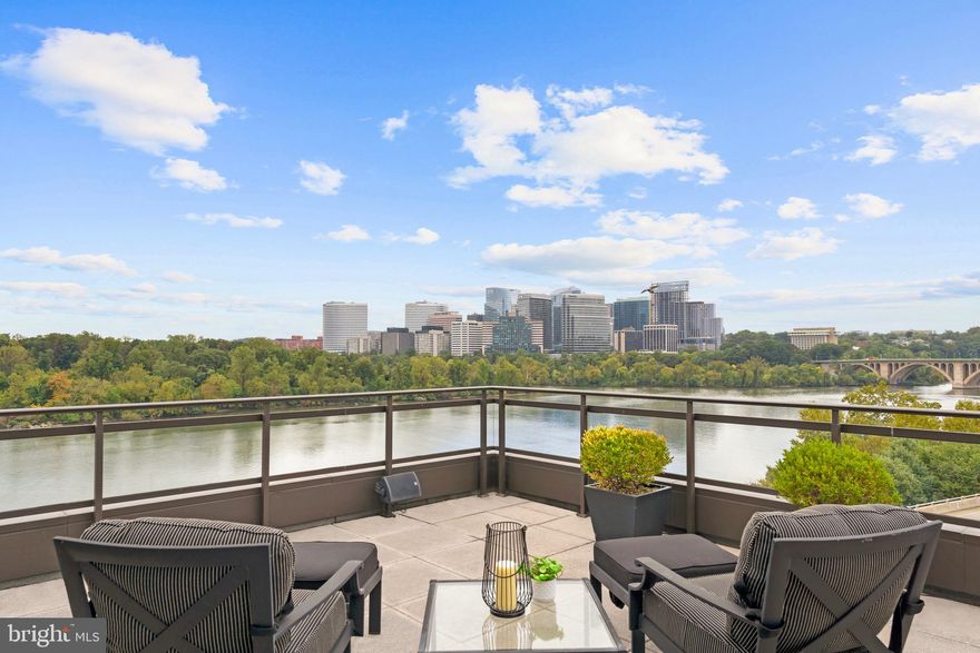 Few brands are as synonymous with service and luxury as The Ritz-Carlton. For decades, the nameplate has been interchangeable with personalized service, opulent accommodations, and a sumptuous lifestyle. In the heart of Georgetown’s iconic Waterfront, as well associated with historic charm and the utmost in prestige, lies Penthouse 2A at The Ritz-Carlton Residences. The largest unit in the building, this mansion in the sky stands above all else in a rarified air of exclusivity. 6,400 square feet of artfully custom hewn interiors open up to more than 3,000 square feet of private terraces, spanning a full 112 feet in length and portraying transcendent, sweeping views encompassing nearly all of the city’s monuments from the National Mall to Key Bridge and the roaring Potomac underneath. A private elevator opens up to the residence, unlike anything else and unlikely to be ever replicated. Gascogne Limestone and Brazilian Cherry floors line grand, ethereal spaces with nearly all embassy-sized primary rooms opening onto the showstopper terrace for seamless indoor/outdoor entertaining. After the sun sets, a roaring fireplace in the formal living room serves as an intimate backdrop to the twinkling Arlington skyline beyond panoramic windows. The kitchen, a poster child for modernity, pairs smooth-faced solid wooden cabinetry with natural stone counters, concealing commercial-grade SubZero and Wolf appliances. A breakfast nook and keeping room open onto a westward-facing patio, enabling alfresco dinners against the pastel backdrop of a Washington summer sunset. The primary suite is a home within a home, with wraparound windows to capture every last bit of the mesmerizing view. An Miele espresso bar, private study or fitness space overlooking the water, and twin dressing rooms and marble baths ensure life on the most lavish scale befitting of The Ritz-Carlton. Three secondary bedrooms, each with an ensuite bath, are all amply proportioned and luxuriously appointed. The custom curved staircase majestically twirls itself up to the upper level, whose custom wood and leather-paneled bar is a gracious functional work of art against an equally stunning view. Plush office space is discreetly tucked away on this level for total tranquility. From the roof terrace, captivating views of the Washington Monument, Watergate, and Kennedy Center to the east, Rosslyn to the South, Key Bridge to the West, and Georgetown’s vibrant historic center to the North are simply unsurpassed by anything else. As is customary for one of the world’s finest five star hotels, an extensive list of individualized amenities convey with the offering. A full-service 24/7 concierge and on-site management in addition to four garage valet parking spaces and access to all hotel amenities creates an effortless lifestyle. An unparalleled location mere steps to M Street and the Waterfront establishes the residence as one of Washington’s finest offerings and enables Penthouse 2A at The Ritz-Carlton Georgetown to make a statement as the crown jewel of the city.