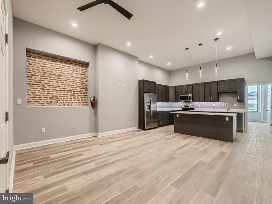 Newly renovated with gorgeous contemporary fixtures and finishes in handsome, secure historic Mt. Vernon rowhome featuring a carved rotunda skylight above an elegantly curving staircase.  Excellent Mid-Town location, just a few blocks from Penn Station, close to MICA, Peabody Conservatory, UB, Walters Art Gallery and the Washington Monument.  A multitude of dining, shopping and nightlife options in the immediate area.  Super high ceilings with recessed lighting add to the grand feel.  Individually controlled central heat and A/C. In-unit laundry.