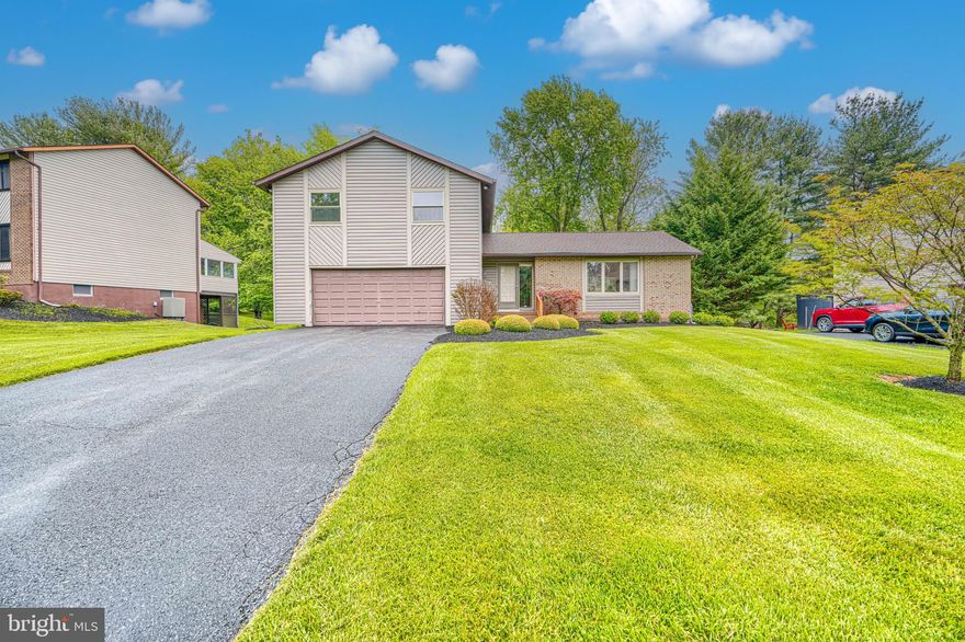 Beautifully updated 4BR/2.5BA split-level in desirable Velvet Hills! This meticulously maintained move-in ready home features fresh paint (2025), new carpet (2024), upgraded insulation, and extensive updates throughout. The upgraded kitchen offers granite countertops, stainless Whirlpool appliances, tile backsplash, coffee bar, pantry, recessed lighting, skylight, eat-in table space, and sliding door to the expansive deck, making it the perfect entertainment space. Hardwood floors and recessed lighting highlight the living and dining rooms, while the sunken family room features custom built-ins, an electric fireplace and access to the patio. The primary suite includes customized closets, new ceiling fan, and a fully remodeled spa-inspired bath (2025) with heated tile floors, marble vanity, oversized walk-in shower with rain head, handheld sprayer, built-in seat, and barn-style custom glass doors. All the 2nd floor bedrooms include ceiling fans and updated closet systems. The finished lower level offers additional recreation space, storage galore, natural light and another walk out to the back yard. Additional highlights include an epoxy-floor 2-car garage, alarm system, Ring doorbell, keyless entry pads, window treatments throughout, attic fan, recently cleaned ductwork, and all new windows on the 2nd level. Major exterior improvements completed in 2025 include new siding, roof, gutters, gutter guards, skylight, and flood lights. Water/sewer lines replaced in 2018; heat pump, sump pump, and water heater replaced approximately 10 years ago.