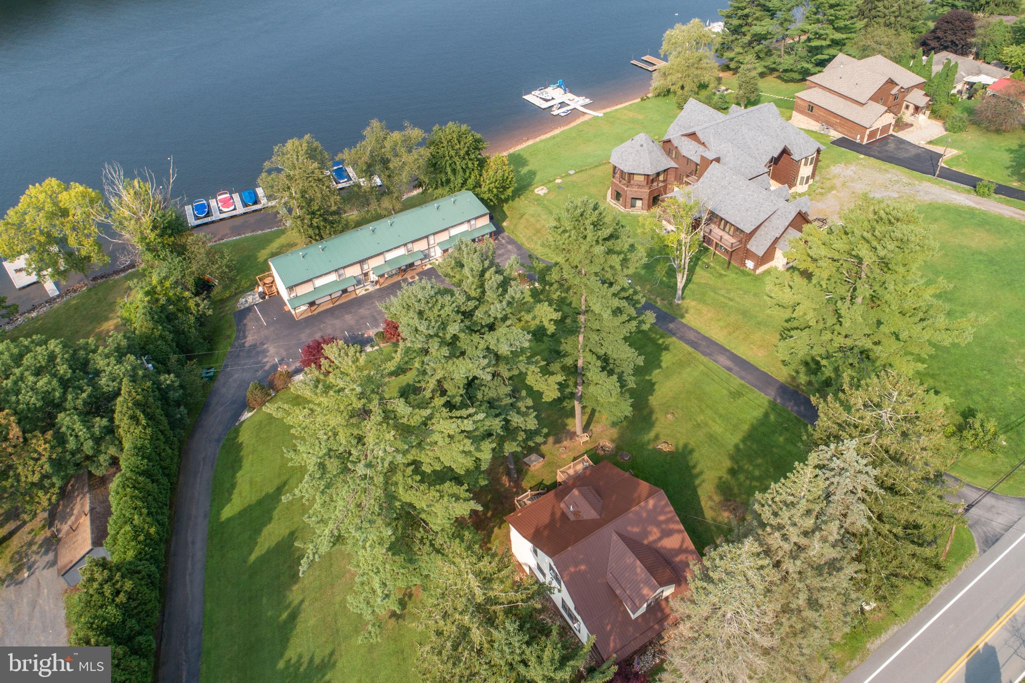 Beautiful lakefront can be enjoyed from the only single family unit located within the Driftwood condominium development. Fabulous views of Deep Creek lake! Easy walk to your lakefront dock slip for boating, fishing, swimming, kayaking etc. Enjoy the privacy of your own home but the convenience of being part of a condominium that takes care of lawn and dock maintenance. This property has been remodeled with all the modern conveniences including a hot tub, and updated bathrooms and kitchen. This lakefront/access property will not last long!