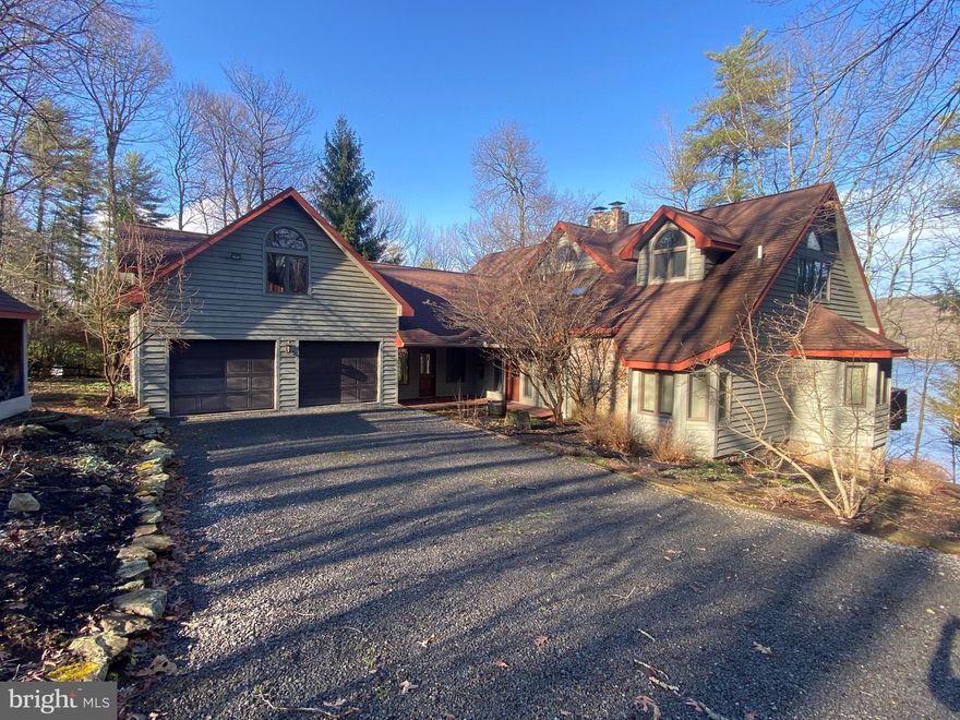 Private lakefront retreat with 200' of quality wooded frontage offering spectacular sunrises and views.  The 4 BR 4.5 Bath 3 level open floor plan has been completely updated including the kitchen, bathrooms, some exterior doors, new garage doors, added air conditioning, instant hot water heater, furnace, appliances, flooring, painting, decks, dock, generator, hot tub, shed and furnishings.   Includes 2 fireplaces and large sweeping deck plus 2 covered lakeside porches and a private office.