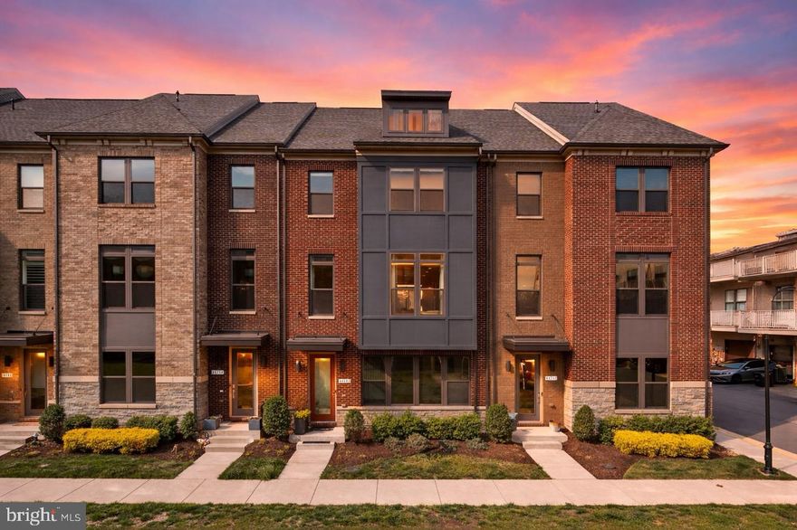 A compelling opportunity in One Loudoun. Experience luxurious turnkey living just steps from the community’s best dining, shopping, and entertainment. This extensively upgraded, impeccably maintained four-level townhome offers 3 bedrooms, 2 full baths, and 3 half baths. Positioned on a premium courtyard-facing lot, this residence features over $100,000 in builder and post-construction upgrades, including a fully renovated kitchen, oversized quartz waterfall island, rooftop terrace, smart home features, custom cabinetry, and an updated primary bathroom.

The entry level provides flexible living space ideal for a home office, lounge, or recreation room, complete with a recessed media outlet for easy conversion. This level also offers access to a fully finished oversized two-car garage with premium custom cabinetry, tool closet, paneling, hooks, and keypad-accessible under-stair storage.

The main level is designed for both everyday living and entertaining, featuring 10-foot ceilings and a fully renovated kitchen (2023) anchored by a dramatic oversized 12-foot waterfall quartz island. Additional kitchen highlights include JennAir appliances, custom shaker cabinetry, under-cabinet lighting, designer backsplash, and upgraded lighting. The open layout connects seamlessly to two large living areas and the dining area, with direct access to a private 19-foot Trex deck.

Upstairs, the extra-spacious primary suite is designed for both comfort and functionality, featuring dual walk-in closets. The updated primary bathroom (2026) includes dual vanities with upgraded light fixtures, smart mirrors, a private water closet, and a spa-style walk-in rainfall shower with bench. Two additional spacious bedrooms and an updated full bath complete this level.

The top level offers a versatile loft or office space with a half bath and direct access to a private 24' x 13' rooftop terrace, one of the most sought-after features in One Loudoun, providing exceptional outdoor living and entertaining space.

Located directly across from One Loudoun’s dining, shopping, and entertainment, with immediate access to Trader Joe’s, Tatte Bakery & Cafe, Arhaus, Williams Sonoma, Bartaco, and more. Approximately 0.5 miles to Weller Elementary and under 1 mile to Topgolf, iFLY, and XCAL.

Community amenities include The Club at One Loudoun with clubhouse, multiple pools, tennis, pickleball, basketball courts, dog park, trails, and year-round events at the Barn.

Convenient access to Route 7, Route 28, the Dulles Toll Road, Dulles International Airport, and the Silver Line Metro.

Additional upgrades include HVAC coil replacement (2022), designer lighting (2022), Hunter Douglas remote-operated shades (2022), full kitchen renovation (2023), washer (2024), smart home features including Ecobee thermostat and MyQ garage system (2024), fully finished two-car garage with custom cabinetry and paneling (2024), top-of-the-line JennAir microwave/oven combo (2025), new smart hood (2025), custom built-out pantry (2025), updated primary bathroom (2026), and hardwood flooring throughout the entire townhome