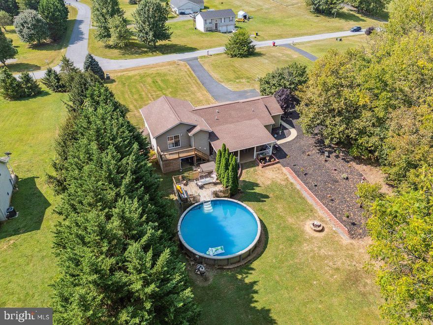 If you’ve been searching for a home that breaks away from the ordinary, this split-level is full of charm and character. Privately tucked on nearly an acre, it offers the best of both worlds, country living while still being close to all the shopping, dining, and conveniences you need.

The backyard is a true retreat, designed for making memories and enjoying the outdoors. Relax on the oversized covered patio, take a dip in the pool with its own private deck, or unwind in the hot tub. The thoughtful landscaping and care from the current owners shine through in every detail.

Inside, the lower level provides a spacious rec/flex room, perfect for entertaining or everyday living, plus a fourth bedroom with ground-level exterior access and a half bath. This setup works beautifully for guests, extended family, or anyone seeking a handicap-accessible space. On the main level, the kitchen and dining area flow directly to the covered patio, extending your living space outdoors. Upstairs, three generously sized bedrooms offer comfort and room to grow.

If you are one who has a desire to want space, character, and a place that truly feels like home, this is it.