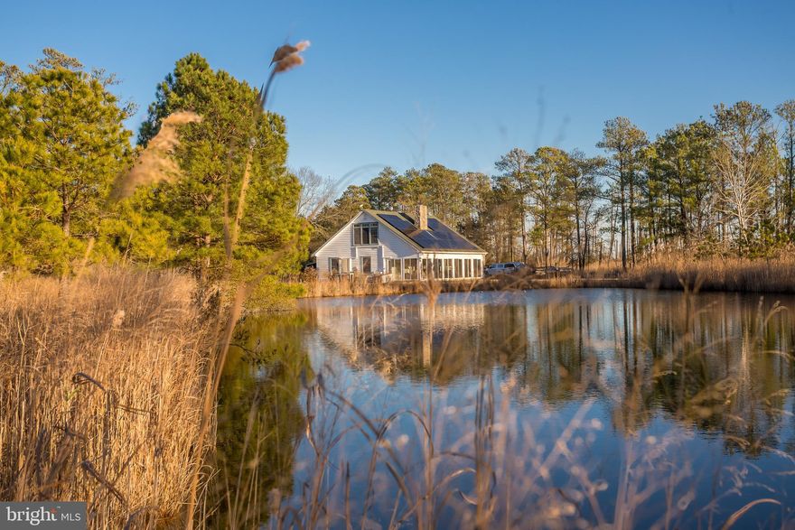 Situated as the last privately owned property on Maple Dam Road before entering Blackwater National Wildlife Refuge, this 10.54± acre offering occupies an exceptional setting surrounded by refuge lands on all sides. The property lies within thousands of acres of permanently protected public ground, providing unmatched privacy, wildlife presence, and long-term landscape preservation in the heart of Dorchester County.

Improvements include a 1,718± square-foot residence powered by a PV solar array, backed by an on-demand 22kw generator delivering efficient and sustainable energy. Climate control is handled by six mini-split systems, with an additional in-box unit conveying with the sale, offering flexibility for future expansion or replacement. The home features two gas fireplaces, with one having an option to burn wood, adding both comfort and versatility. A four-person hot tub is included, creating an ideal space to unwind and watch the sunset.

A 30’ x 30’ garage with 14-foot ceilings provides ample room for boats, equipment, and sporting gear. in addition to the large garage, a climate-controlled office/workshop is just steps away from the main house. The land itself is highlighted by natural marsh ponds and wetlands, enhancing habitat and contributing to the area’s outstanding waterfowl hunting and well-established Sika deer population.

This property offers a unique opportunity to enjoy legitimate hunting and outdoor recreation from a private home site while being fully immersed within one of Maryland’s most iconic conservation landscapes. Whether used as a full-time residence, weekend retreat, or generational sporting property, Maple Dam Road delivers an exceptional blend of access, privacy, and outdoor heritage that is increasingly difficult to find on the Eastern Shore.
