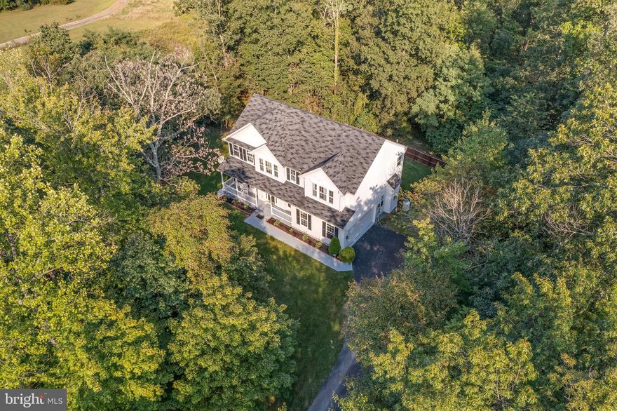 Looking for a home in the country with some privacy?? Found it - along with a beautiful 4 bedroom  colonial.    The views all around this home in the fall are stunning.  In the winter, you can see the mountains.  And you'll love the home.  Bamboo floors on the main level, an island kitchen with granite countertops,  there's an open flow from the kitchen to the family room with a fireplace, and a sunroom with big windows to enjoy the view in back. Upstairs, there's 4 bedrooms - the master suite is huge and the other bedrooms are a good size. There's an unfinished basement plumbed so you can finish for even more space. You've got very nice neighbors (as pointed out by the sellers) but you don't see them thanks to the 3.56 acres surrounding the home and next to homes also on large lots.  Tomahawk Run in Hedgesville is a  wooded community of large homes on large lots and it's not often one comes up for sale. There is an HOA but it's relaxed - another thing to like about this home.   Dues are just $100 a year to take care of the roads. Sellers are heading south and very motivated.  All offers considered.  Someone is going to get a great deal.