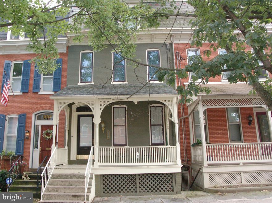 Chestnut Hill Neighborhood.  Nice 4 bedroom. 1.5 bath townhouse with economical gas heat and central air conditioning. This home features hardwood floors, formal living room and dining room with ornate trim.  Modern kitchen with exposed brick and quaint breakfast area.  Cozy front porch and rear brick patio in private fenced yard.   Additionally, there is a rear one bedroom one bath cottage for potential extra income.