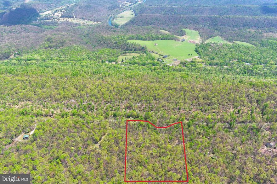 FLYIN' HIGH ON EAGLE MOUNTAIN.....9.2 ACRES WITH ALL KINDS OF INTERESTING FEATURES; ABOUT 3 ACRES OF LEVEL GROUND ON TOP OF THE MOUNTAIN AT 1600 FT OFFERING GREAT VIEWS TO THE NORTHWEST, COVERED IN HARDWOODS WITHOUT A PINE IN SIGHT, GORGEOUS ROCK OUTCROPPINGS AND NETWORK OF OLD LOGGING ROADS PROVIDE GREAT ATV TRAILS AND ACCESS TO THE ENTIRE LOT. OBSCURE DRIVEWAY LEADS TO ANCIENT CAMPSITE DEVELOPED BY THE OWNERS IN THE 80'S, THIS LOT IS SO GOOD THE OWNERS HAVE HELD ON TO IT FOR 42 YEARS! WITH MINIMAL WORK, YOU COULD PULL A CAMPER INTO THE OLD CAMPSITE AND BE WITHIN 200 FT OF ELECTRIC. LIKE TO HUNT? BUCKS, BEAR & BOBCAT ROAM HERE. LOCATED IN THE WELL MAINTAINED GATED COMMUNITY OF EAGLE MOUNTAIN, 10-15 MINUTES FROM THE VILLAGE OF PAW PAW AND PUBLIC ACCESS ON THE CACAPON AND POTOMAC RIVERS FOR UNLIMITED FUN ON THE WATER. JUST A HAIR OVER 30 MINUTES FROM WINCHESTER, VA AND 2 HOURS FROM DOWNTOWN DC.....HANDS DOWN THE BEST DEAL OUT THERE ON 10 ISH ACRES......IT'S TIME TO GET YOUR SLICE OF THE PIE, YOU'VE EARNED IT AND YOU DESERVE IT.....BREAK OUT THE COONSKIN CAP AND HEAD FOR THE MOUNTAINS!