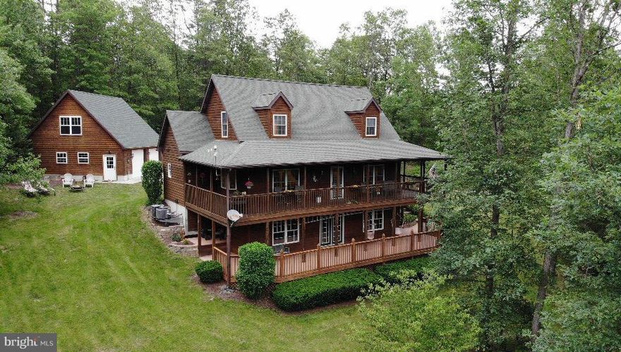 Custom-designed, country inspired, creek front home on over 7 acres with limited restrictions.  The home features multiple decks exposed to views of Three Run Creek, great for entertaining.  Space for up to 5 Bedrooms featuring a Main Floor Master Suite and 3.5 Bathrooms.  Large eat-in kitchen opens into Family Room & Professional Office.  Deed access to Opequon Creek for water activity.