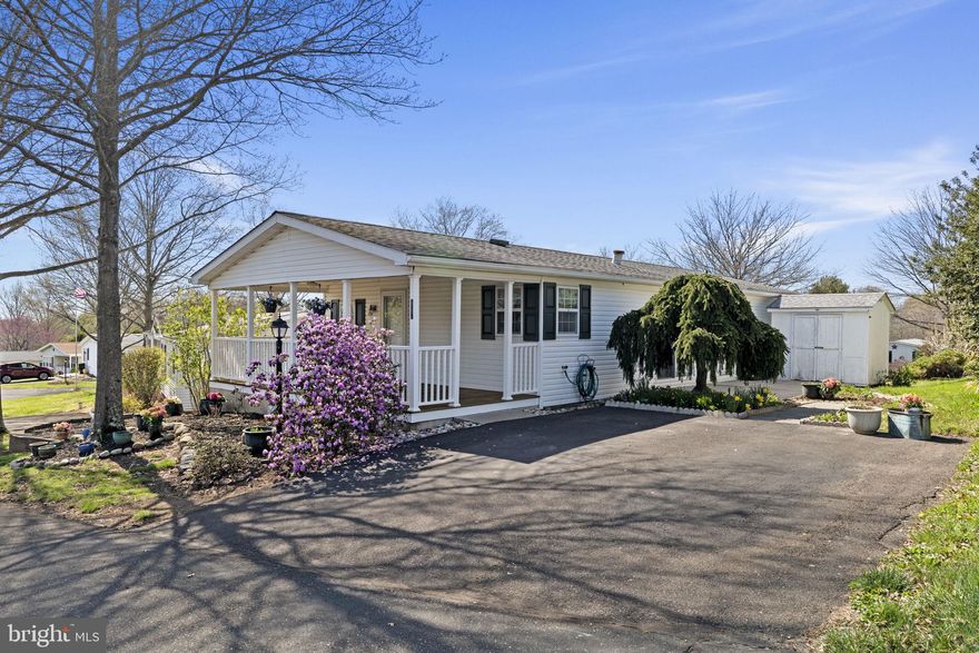 Welcome to 442 Manor House Lane, nestled within the highly sought-after Hidden Springs 55+ community, where everyday living feels like a retreat. Surrounded by rolling grassy meadows, bursts of wildflowers, and a canopy of mature shade trees, this vibrant neighborhood offers a picturesque setting designed for both relaxation and connection. Enjoy peaceful strolls along the newly paved walking paths, unwind by the pond with its charming fountain, or gather with neighbors at the gazebo and clubhouse, the heart of this welcoming community.

As you arrive, you are greeted by beautifully curated landscaping that creates a true outdoor oasis. The expansive front porch invites you to slow down and savor your morning coffee or evening conversations, while the private side patio offers the perfect setting for al fresco dining or quiet moments surrounded by nature. A spacious shed provides added convenience for storage or gardening essentials.

Step inside to discover a bright, airy home filled with natural light and thoughtfully designed for easy, one-floor living. The living room welcomes you with vaulted ceilings and an open, inviting feel that seamlessly flows into the dining area and kitchen. The kitchen is both functional and charming, featuring ample cabinetry, generous counter space, a pantry for extra storage, and corner windows above the sink that frame views of your peaceful outdoor setting. Sliding glass doors extend your living space outdoors, creating an effortless connection between inside and out.

The primary suite offers a comfortable retreat with a walk-in closet and a private en-suite bath. A second bedroom and full hall bath provide flexibility for guests, a home office, or additional living space to suit your needs. A dedicated laundry area adds to the home’s everyday ease and convenience.

Life at Hidden Springs is all about simplicity without compromise. Residents enjoy access to a clubhouse, pool, and scenic walking paths, all designed to support an active and social lifestyle. Ideally located near shopping, dining, and major roadways, this home also offers easy access to nearby destinations such as Peace Valley Park, the charm of Doylestown, and the convenience of Montgomeryville Mall.

Experience the perfect balance of tranquility, community, and convenience. This is more than a home, it is a lifestyle designed to be enjoyed.