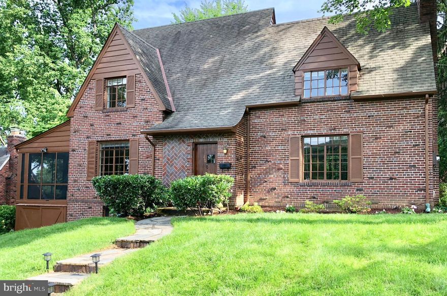 Classic Del Ray Tudor offering 3 spacious bedrooms, 2 full baths, wood burning fireplace and exposed beams in living room, hardwoods throughout, built-ins, updated kitchen with loads of storage, granite, & stainless appliances, Charming, airy screened porch, extensive hardscape and one car garage. Great possibilities for finished space in basement. Walk to Metro, "The Avenue", parks & trails.