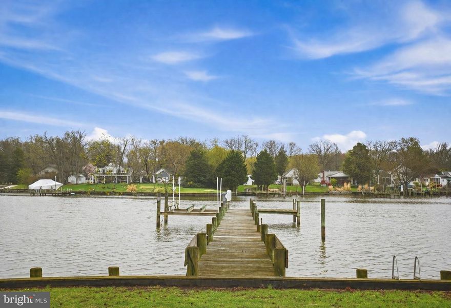 Experience true waterfront living in this beautifully updated 2-bedroom, 2-bath home. From the moment you step inside, you’re welcomed by an inviting foyer highlighted by a stunning curved staircase—setting the tone for the home’s elegance and charm.

The main level features durable luxury vinyl plank flooring throughout, while the primary bedroom offers fresh, plush carpeting for added comfort. The spacious, light-filled kitchen is a true standout, boasting abundant prep space and storage—perfect for both everyday living and entertaining.

The large dining room is filled with natural light from skylights above and features sliding doors that open to a Trex deck overlooking the water. Enjoy peaceful views or head down to your private pier with a 10,000 lb boat lift—ideal for kayaking, jet skiing, or simply relaxing by the water.

Step outside to an expansive backyard designed for unforgettable summer nights, gatherings, and waterfront living at its finest. Additional highlights include an oversized driveway offering ample parking .

A rare opportunity to own a move-in ready waterfront home that perfectly blends comfort, style, and outdoor living.

✨ No flood insurance required