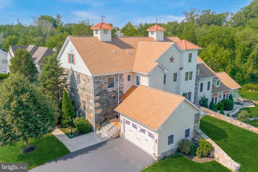 Two worlds collide: preserved history and modern convenience. Unique Barn Conversion  from an historic  230 year-old Pennsylvania stone bank-barn.  Cornerstone Barn is listed as a class 2 historic structure (The Thomas Hill Brinton Barn) and also a one-of-a kind custom-built home which is adjacent to dedicated open space.  Essentially new construction in 2007 but loaded with history as this design incorporates the stone wall remains of an 1804 Quaker-Built Barn with the earthen ramp and stone walls fully restored. Description: First floor has an attractive front porch into a large light-filled Foyer, a separate Home Office, Living Room, Dining Room, Family Room and Kitchen w/ breakfast area.  Here the flooring is all oak hardwood flooring just sanded and refinished with a light cherry/gunstock stain.  Granite tops in the timeless and rich Rosewood Kitchen.   Second floor has three bedrooms, two baths and a full-featured laundry room and stairs to the 4th bedroom/suite.   The walkout  Lower Level is fully finished and brings the living area up to 4,900 sq ft.  and includes a full bath plus a Kitchenette and it also has an area that could be utilized as an in-law suite or 5th bedroom.  The two-car garage has an extra-wide and extra-tall garage door (18' x 8') and an inside entrance to Foyer.   Despite all of the space, the home is still a good fit for just a couple because the square footage is spread out over 4 levels and "elevator ready" (estimates in Docs).   Not a huge warehouse home and definitely not a cookie cutter or tract-built house!  Extraordinary large scale and elegantly finished w/10 foot ceilings, oversized custom woodwork, open concept with large public spaces provide a grand feel, window seats, lighted cupola, weathervane,  Andersen wood/fibrex tilt-in windows, 2 high-efficiency HVAC systems,  sumptuous Primary Retreat.   There is a Secondary Retreat as well that is set apart on a separate level and also features a jumbo bedroom and bath.   Ceiling fans and large closets throughout. Live in history but still enjoy a modern and low-maintenance home because it is on a small lot (1/4 ac) and semi-detached  and inexpensive to maintain.  Adjacent open space is mowed and maintained by the Cherry Creek Homeowners' Association (HOA) which  is a Conservation Community w/ over 100 acres of open space which  includes approx 4 miles of mowed off-road  walking trails and 3 miles of upscale neighborhood sidewalks.  The HOA fee is $95 mo and includes the open space management  & 2x week trash pickup.  Thornbury  Twp is the "Jewel of the Region", a Twp. without 1 traffic light and no (none) real estate taxes (but has a 1% earned wage tax) and very convenient location: less than 3 miles to 5 groceries and 1 mile to Wawa and Giant.   Close to nearby historic sites including the Brandywine Battlefield where the 9/11/1777 Revolutionary War Battle was fought and the British soldiers recuperated at this very location on the former farm.  Later it was a stop on the Underground Railroad with a hideout room in this very barn.  Remarkable for the large cornerstones & the even LARGER IMPRESSION  that this home leaves on those that see it.  It was built in 2007 in the stone wall remains of the 1804 stone bank barn that was part of the prior farm on this property which was from a William Penn Land Grant to William Brinton in 1684 (great history!) and abuts abundant open space. The semi-detached design keeps the taxes and utility costs low but it seems like a detached home as you live here, even to your guests and delivery men!   Home has just undergone a light  remodel including  sanding and refinishing floors, new HVAC,  fresh paint, new appliance, all new carpeting and much more.  Seller just installed a new 14 x 12 composite deck off of the breakfast area. Move-in ready & turnkey.  See the history in the documents sections and displayed in the home along with items from the archaeological dig on-site.