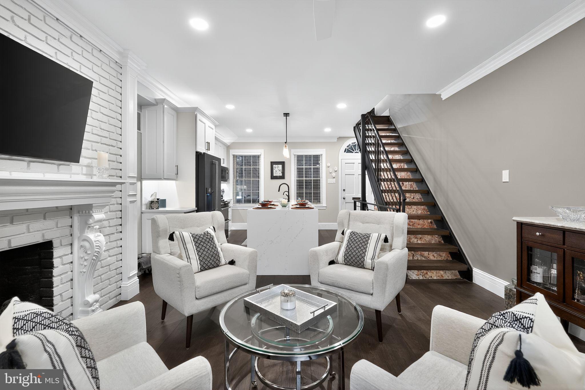 Experience the height of city living in this gorgeous Federal-style townhome in the heart of Washington Square West.
Featuring 3 bedrooms plus a den/office, 3 spa-inspired bathrooms, and a fully finished basement. This home blends timeless charm with modern luxury. The open-concept main floor showcases solid oak hardwood floors, high ceilings, crown molding and recessed lighting throughout. The chef's kitchen has a Cambria quartz waterfall island, countertops and seamless backsplash with solid wood cabinets and upgraded GE Cafe matte black appliances. Exposed brick walls, a gas fireplace with marble thresholds, and oversized glass doors extend the living space to a private walled garden and patio-perfect for entertaining or unwinding. Upstairs, two generous bedrooms feature custom closet systems, There is Juliet balcony access from the second floor primary bedroom with a primary bathroom that is fully tiled with Carrara marble and absolute black granite floor. The top floor is dedicated to a recently renovated guest suite with heated tile floors, glass-enclosed shower, built-in storage, and an adjoining den/home office designed for today's lifestyle. The fully finished basement provides an additional media/family room, multiple storage closets, and updated mechanicals, creating both functionality and flexibility. Nestled in the coveted McCall Elementary School catchment, this home offers a Walk Score of 99, placing Center City's finest restaurants, cafés, shopping, nightlife, and cultural destinations just steps away.
Offering the perfect balance of elegance, convenience, and vibrancy, this residence represents urban living at its absolute best. Schedule your appointment today to experience this exceptional property.