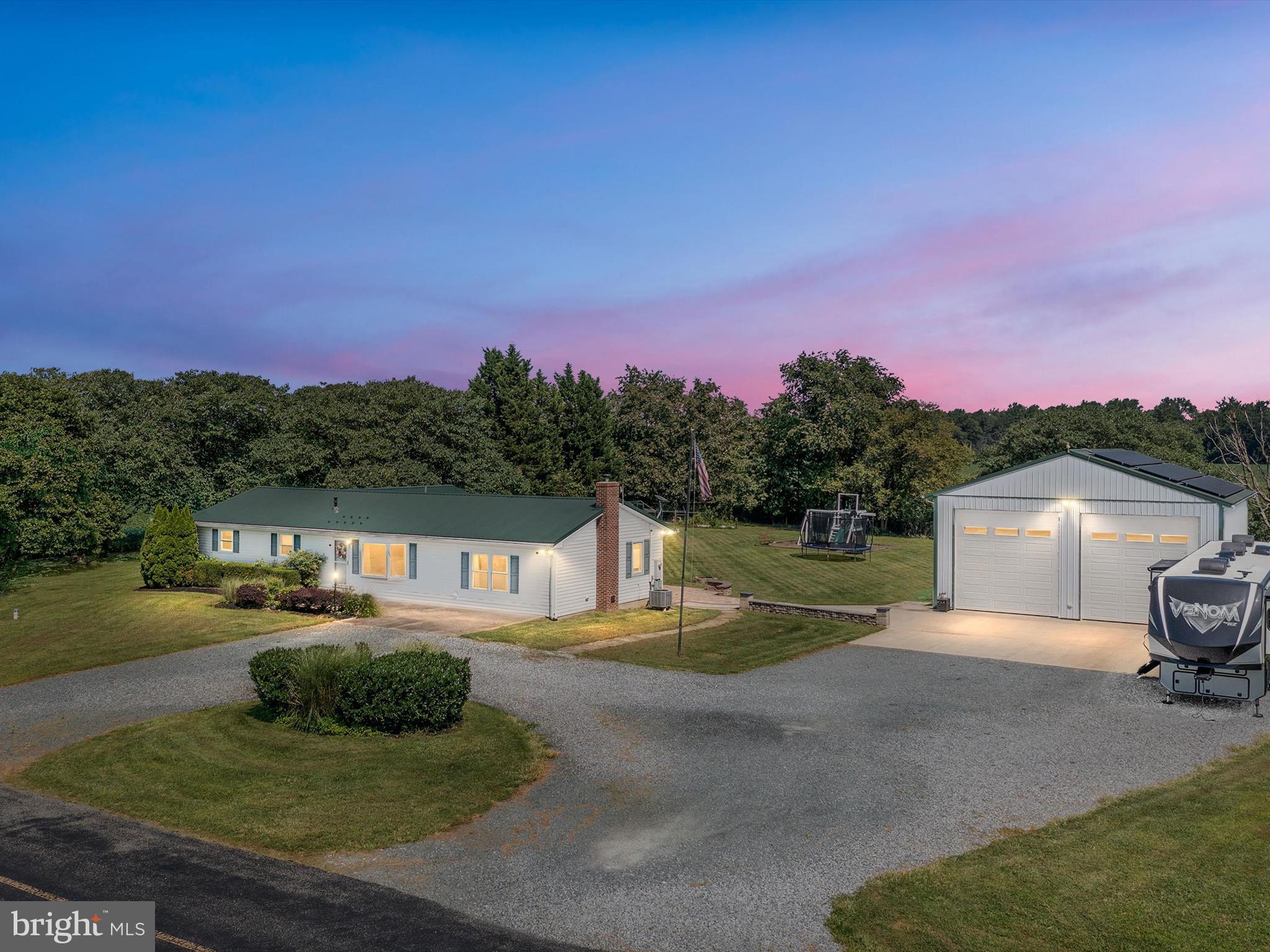 This property has it all, including beautiful scenic 360-degree views of rolling country fields. The property has manageable landscaping, a large paver patio deck with built-in benches and a fire pit, and huge parking area with plenty of space for guests. The huge shop has water, electricity, heat, and air conditioning. The home has been recently renovated, including opening up walls to create an open floor plan, a new metal roof, an upgraded kitchen, new cabinets and countertops, new HVAC and tankless water heater, new windows, a large master bedroom addition, new insulation, and more. Solar panels on the shop significantly reduce the overall electric bill. The home is located just minutes from Route 301, 25 minutes from the Bay Bridge, and 30 minutes from Middletown. This is a must-see home! Call today for more information.