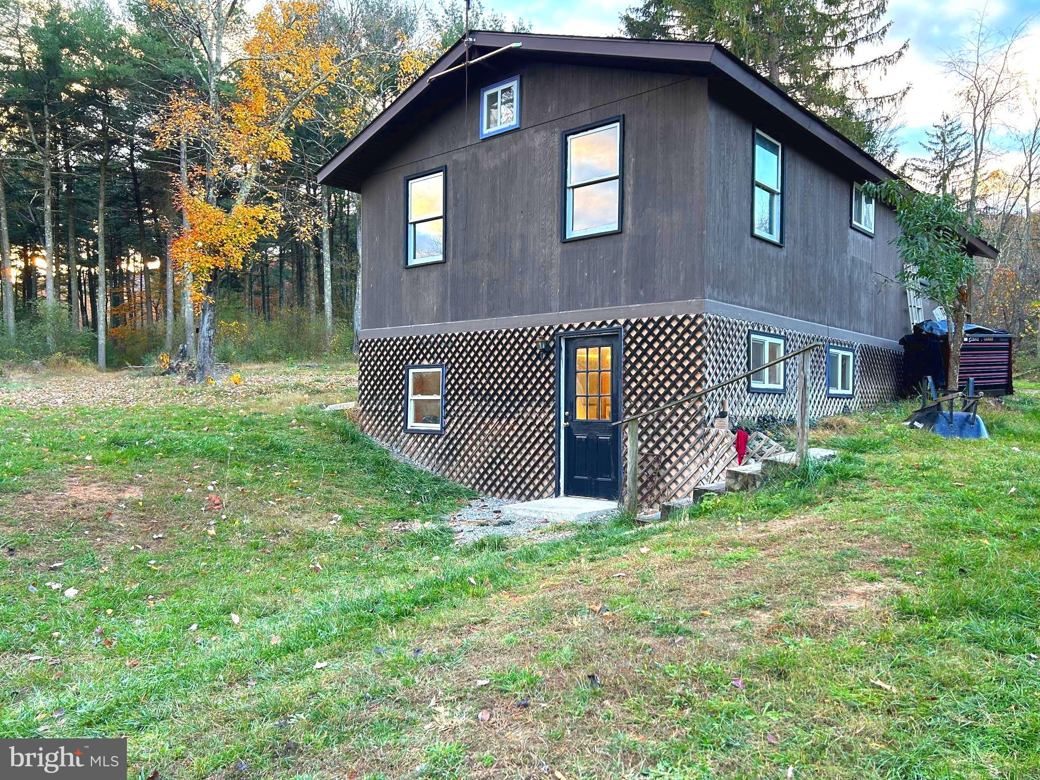 SERENITY NOW! Peace and quiet on your secluded 6+ acres, yes still only 30 minutes to Winchester and 25 minutes to Romney! This adorable gem has gleaming refinished floors, a new well pump and pressure tank, and a recently refinished bathroom, complete with clawfoot tub! The inviting, open floorplan great room offers a home-warming AND heart-warming woodstove on the living room side (ESPECIALLY ON THOSE CHILLY NIGHTS) and the kitchen is spacious and has stainless steel appliances. Underneath, there's also a partial finished basement and outside, there's woods in ALL directions. The community offers a fishing pond, as well as huntable common land. Common land borders this property on three of the 4 sides. The owners say all the neighbors are great! Make this home your daily rural retreat from the craziness of city life! IF YOU LIKE WHAT YOU SEE, CALL !!!!!!!