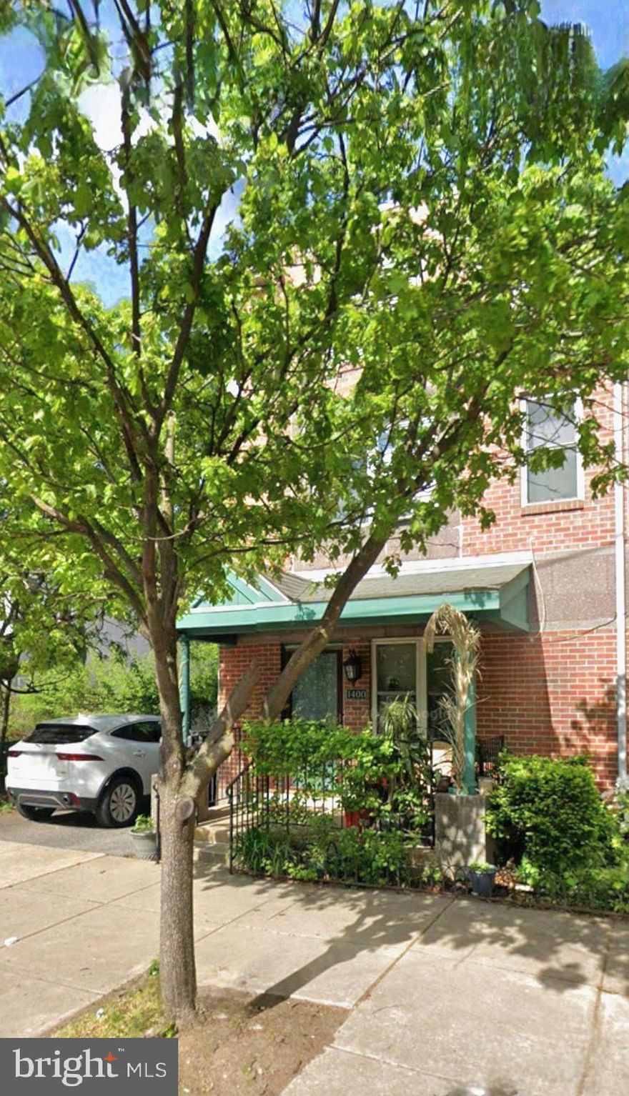 1400 North Bouvier Street is a 1,628-square-foot, four-bedroom, two-bathroom town home in Philadelphia's Temple University area, built in 2002. It features a straight-thru design with a front porch, an open-concept main floor with an updated kitchen and main floor laundry, a spacious backyard, and a one-car driveway. The home also has central air conditioning, forced-air heating, and is located in a very navigable and transit-friendly neighborhood.