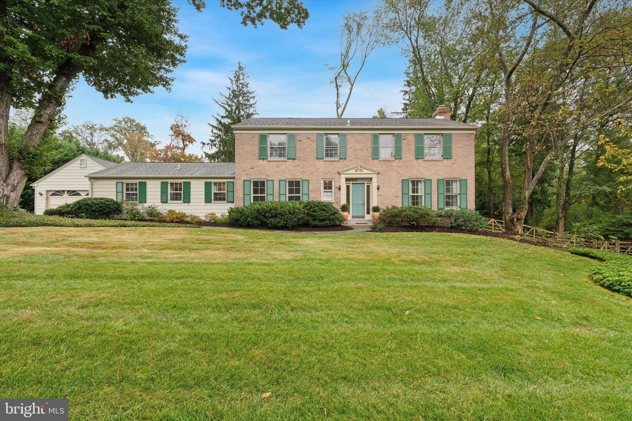 Beautiful brick colonial offering 3,234 square feet of above grade living space, 4 bedrooms, 3 full and one half bathrooms, two-car front entry garage, and a gorgeous one acre level lot with well manicured landscaping. Main level includes updated kitchen with custom white cabinetry, granite countertops, center island, subway tile backsplash, and stainless steel appliances including Wolf wall oven and induction cooktop, sunken living room with wood burning fireplace, sunroom with wood trim, slate floor, pellet stove, and exposed stone walls, a full and a half bathroom, and two additional bonus rooms to suit any buyer's needs. Upstairs you'll find the primary bedroom suite with spacious sleeping area, dressing room with 2 closets, and a full bathroom. 3 secondary bedrooms, a full hall bathroom, and walk-up attic stairs complete this level. The partially finished basement offers tons of storage and a great canvas to create additional living space. This home is conveniently located close to all major commuter routes, shopping, dining, private schools, prestigious country clubs, and is part of the top rated Tredyffrin-Easttown School District. Listing agent is a member of the LLC that owns this home.