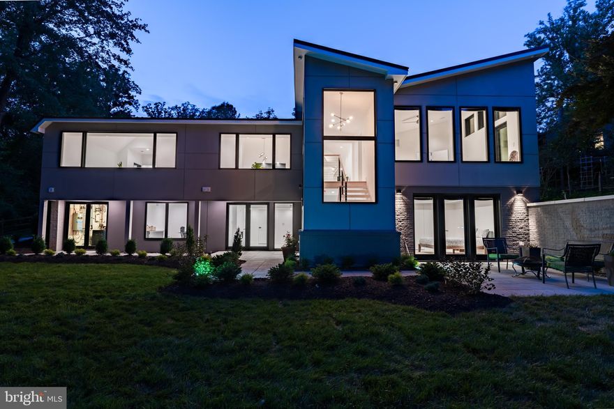 *PLEASE READ: OPEN HOUSES HAVE BEEN CANCELLED* Welcome to your modern dream home in Potomac! Newly completed in June 2022, this multi-year expansion and complete rebuild spared no expense! Stunning modern design aesthetics throughout. Breathtaking lines at every turn, adorned with tasteful finishes and a sophisticated color palate. Imagine yourself coming home to a pristine and luxurious renovation that will WOW you every time you walk in the door. Plentiful and oversized windows envelop the house, bringing in amazing natural light while also providing picturesque natural green views of the surrounding trees and extensive landscaping. The dramatic ceiling lines on the main level masterfully complete the sought-after asthenic of a true open floorplan. The living room, dining room and kitchen effortlessly flow together in harmony. The chic chef’s kitchen features top of the line gourmet appliances throughout including BlueStar Refrigerator and Range, Bosch 800 Dishwasher, a 3 zoned multi-temperature controlled wine fridge, and so much more! The main level also includes a formal foyer, powder room and hallway, along with a spacious primary and secondary suite. This stunning masterpiece of modern design continues via floating staircase to the ground level family room where you are greeted by walls of glass and a futuristic electric “fireplace”, which leads to the oversized 3rd bedroom guest suite with steam shower, 4th bedroom with a dual entry 4th full bath off hallway and 5th full bath with a deep soaking tub. The former 5th and 6th bedrooms make for a perfect home gym, office, theater, or any other type of flex use! The spacious and bright ground level is a full-walkout with patios and a lovely backyard. Multiple convenient entrances throughout, including in the laundry room which doubles as the mudroom. Exterior features include a new metal standing seam roof, full house Generac back-up generator with automatic transfer, multiple wood decks, walkways and custom landscaping. Entire house is equipped with SMART HOME technology including Apple/Google/Alexa controlled Lutron lighting and ceiling fans, Nest front door lock, front doorbell security camera and HVAC controls, plus additional exterior 4K security cameras, recessed in-ceiling speakers, and a mesh Wi-Fi network to ensure coverage throughout the home. A re-imagined Modern Carport completes the aesthetic with EV charging capability. Ideally located close-in with convenient proximity to Potomac Village grocery stores, dining and retail. Estimated  4,300 interior sqft. *HURRY! THIS AMAZING OPPORTUNITY WONT LAST LONG!*