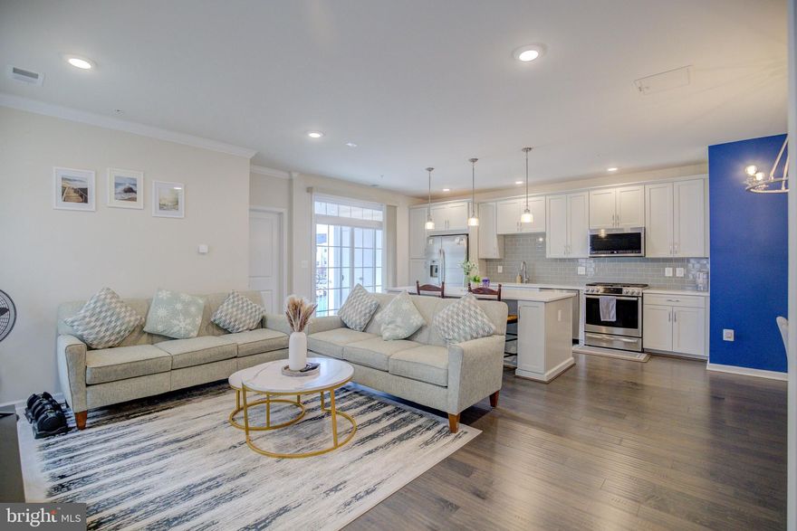 Welcome to this Luxury Garage Townhome style Condo so light & bright with a Southern exposure!  You will delight with the Elegance and Conveniences in this contemporary 3-Level home with no unit above or below.  Features include:  3 bedrooms, 2.5 baths, with Gleaming Hardwood Floors on the main level and foyer.  The Open-Concept main level, with 9 ft. ceilings, recessed lighting, and crown molding, contributes to a stunning Gourmet Kitchen which includes a large center island, pendant lighting, granite countertops, subway tile backsplash, stainless steel appliances, & a gas range.  The kitchen is open to a formal dining space and great room that is perfect for relaxing or entertaining family & friends with a convenient balcony and half-bath.  The main level has a desirable Bonus Room off the living area that can be used as a home office or third bedroom!  The upper level features a spacious primary bedroom with a walk-in closet and a private ensuite bath with a double-vanity and granite countertop.  The well-sized secondary bedroom also has its own private en-suite bathroom.  The laundry is located on the upper level for your convenience.   Excellent parking too as it offers an attached Garage complete with an EV Charging Station and has an additional long, private driveway for added ease and convenience.  The community offers a wide range of amenities including:  3 clubhouses with pools, tennis/pickleball, volleyball, & basketball courts, fitness centers, yoga studio, tot lots, walking/biking trails, & outdoor grilling areas.  Great location convenient to restaurants, shopping, major commuter routes, metro, and schools.  Close to Brambleton Town Center, Park & Ride, Silverline Metro, Routes 28, 29, 50, Loudoun Co. Pkwy., and Dulles Toll Rd.  Just move-in and enjoy modern living at its finest at the Ridges at Loudoun Valley!