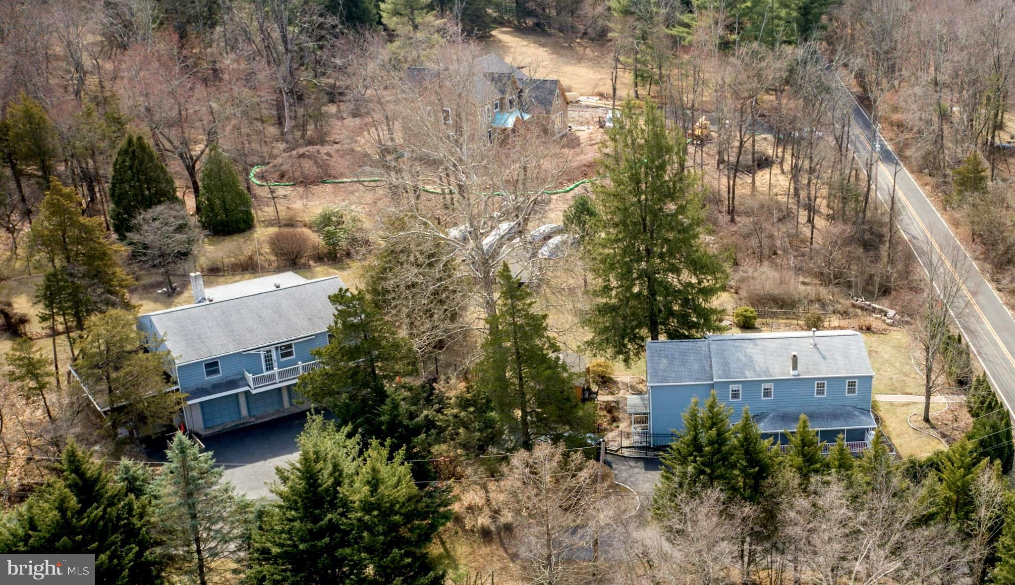 This is an opportunity to own two homes side by side in New Hope. Create a family compound or live in one and rent the other. The main house has been in the same family for three generations and the 2nd house was built to accommodate family members. Both homes are on individual parcels (.34 acre and 1 acre) so either can be sold or rented separately. The original home, 242 S. Sugan, has a combination of hardwood, vinyl and carpeted flooring, a wood stove in the living room, insulated windows, central air conditioning and six bedrooms. Both front and side porches provide entrances to the home and a kitchen door opens to the back deck/patio and rear yard. With additions over the years, the 2700 sq. ft. home is ready for you to add your personal touches to suit your taste and style. The main floor has large rooms, an eat-in kitchen with stainless appliances, a full bath and first floor bedroom. The other house (244 S. Sugan) is 1584 sq. ft. on one level over the enormous garage. It has been recently renovated with new flooring, carpet and freshly painted. There are two bedrooms and two full baths, central air, oil hot water baseboard heat. A large multi-windowed 3-season room looks out over the one acre of fenced garden areas and woods. The four bay garage can be used to suit your needs and lifestyle, and there is an attached carport for an RV or boat. Both homes are covered by a one-year home warranty. Taxes for 242 are $3,854 and for 244 $4,884 (MLS#PABU2089512 and PABU2089536). The location is close to downtown New Hope and its shopping, dining, entertainment and recreational attractions. Nearby are commuting routes to Princeton, Philadelphia, and NYC. These homes can be purchased separately or in conjunction with the property next door. Well water and public sewer.