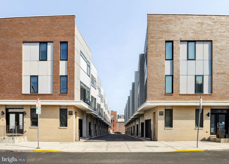 Welcome to your dream home in one of Philadelphia’s most sought-after neighborhoods, South Kensington. Located just a few blocks from Fishtown and Northern Liberties, you’ll be steps away from award-winning restaurants, trendy breweries, boutique shopping, and vibrant nightlife. With easy access to public transit and major highways, commuting is a breeze. This stunning newer construction townhome offers the perfect blend of style, functionality, and location, all while featuring 1-car garage parking and 2 years remaining on the tax abatement, never worry about fiding a parking spot again!
The first floor offers the convieniet garage parking with interior access, and the versatility with a bedroom or home office option on this level and full bath, plus a private back patio. Upstairs, you will be greeted by an open-concept floor plan with a large living/dining room that is bathed in natural light, thanks to oversized windows with custom blinds, and sliding glass doors to a juliet balcony.  The chef-inspired kitchen is a showstopper, featuring a quartz countertops, an island with seating, stainless steel appliances, and sleek modern cabinetry with a pop of color on the tiles,  creating the perfect space for hosting friends or relaxing after a long day.  Retreat to the primary suite on the third floor with a walk-in closet and your spa-like ensuite bathroom awaits with a floating dual-sink vanity with a LED mirror, and a luxurious walk-in shower with frameless glass doors. On this level you also have your third guest bedroom and and a full bath and linin closet. The true gem of this home is the expansive roof deck, offering breathtaking city views and the ultimate spot for outdoor entertaining with cable connection for your outdoor TV, or unwinding under the stars in the evening after a day at work. Need extra space? The large basement with high ceilings make this a perfect area for a home gym, office, or lounge.  Don’t miss this chance to own a modern home with garage parking, and tax savings, and low HOA fee's in one of Philly’s hottest neighborhoods.