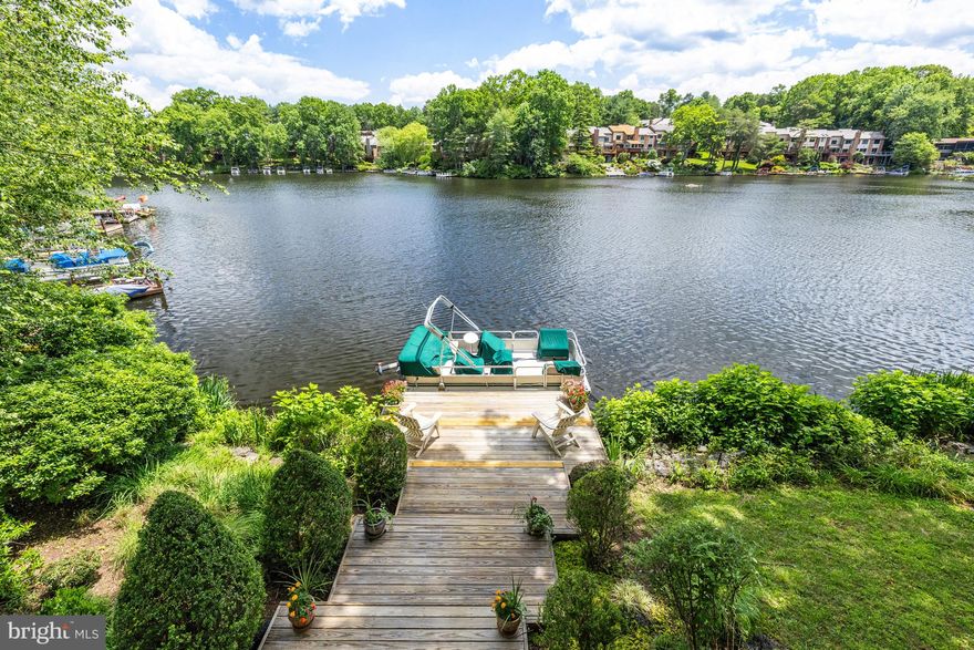 Welcome to waterfront living on Reston's Lake Audubon! This is a great opportunity to own one of the premier waterfront lots in Reston. Get ready to enjoy sweeping, 180-degree views of "big water" from two, wrap-around decks and every level of the home. This 3,200 square-foot custom deck home offers ample living space, inside and out. With 4 bedrooms and 3 full baths and a powder room, coupled with comfortable living spaces, this home is ready to "check off the boxes" of everything you are looking for in a waterfront home. There are hardwood floors throughout. All bathrooms have been beautifully updated and upgraded. The table-space kitchen has stainless steel appliances, gas cooking, a center island, granite counters, built-ins, a vaulted ceiling, and a sliding glass door to the main level deck - super convenient for grilling and entertaining. The open floor plan in the main living area is great for casual entertaining, and the dining room also has a sliding door to the deck. The living room and dining room both have sweeping, unobstructed views of the lake throughout the year. There is a loft which overlooks the living room, kitchen and foyer. The primary suite has a vaulted ceiling, great lake views and an en suite with a separate shower and soaking tub. One level down from the main level are Bedrooms #2 and #3 and a full hall bathroom. The ground level has a recreation room with a wood-burning fireplace, built-ins and a sliding glass door leading to the lower deck, private dock and lake. This is a great, extra living space for entertaining family and friends! The fourth bedroom and the third full bathroom are on this level as well. The bedroom has a large wall of windows overlooking the lake! There is also a workout room or bonus room on this level with an additional storage closet. This home has great storage throughout, with extra storage in the primary suite, loft, workout room, and an extra large attic space with a fixed staircase above the oversized, 2-car garage. The outdoor space is awesome! With beautiful hardscaping and landscaping, and two decks which connect via the side staircase. Plus, you have your own private dock just off of the lower level deck! LOCATION: What an amazing Reston location! Enjoy launching your pontoon boat from your private dock, paddleboarding, kayaking, canoeing, and fishing! COMMUNITY: Easy walk to South Lakes Shopping Center - with Safeway, CVS, and local favorite spots - Red's Table and Cafesano (dining), Reston Floral, and more! Close to major commuter routes with easy access to the Dulles Toll Road at the Reston Parkway, Wiehle and Hunter Mill exits. The Wiehle Ave. Metro Station is just over a mile away! Dulles Airport is less than 10 miles away. Enjoy the miles of walking paths Reston offers, as well as other trails it easily connects to, including Twin Branches Nature Trail, the W&OD Trail and the Cross County Trail! Enjoy Reston amenities including the pools, tennis courts, the Reston Community Center, Walker Nature Center, arts programs and more! Enjoy waterfront living on Lake Audubon every day! CLICK ON THE VIDEO ICON AND CLICK THE MENU TO VIDEO TO WATCH TWO GREAT VIDEOS OF THE HOME!