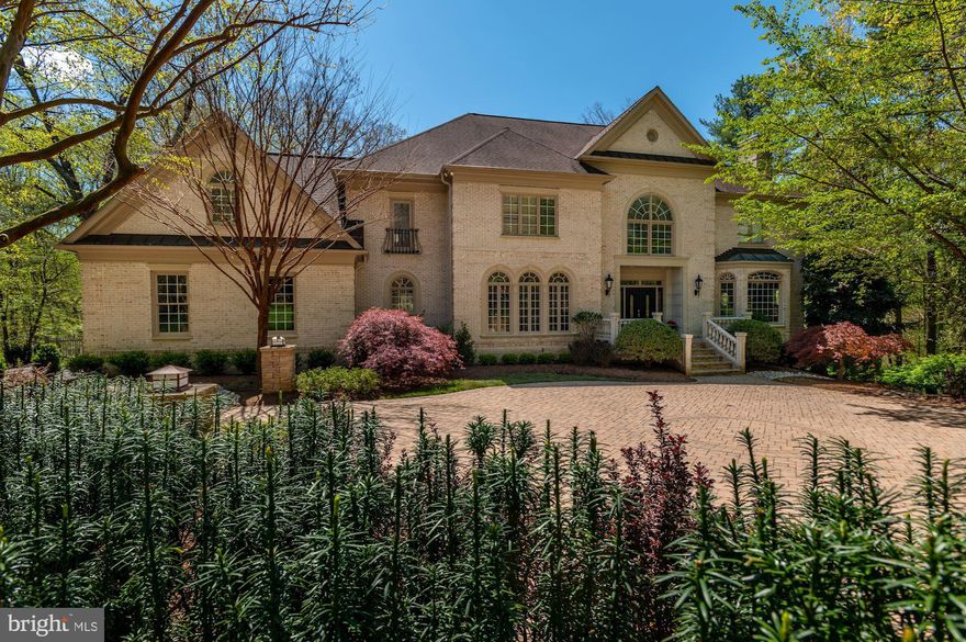 True resort living presenting unparalleled privacy with over 9,000 total SF of living space. Ideally sited on 5 acres of woods backing to parkland, this gorgeous brick colonial features floor-to-ceiling windows, gracious rooms and an ideal floor plan complete with  every modern convenience.  Serenity and tranquility abound for the discerning buyer of this incomparable offering. The main level features a gourmet kitchen with all new stainless steel GE Profile appliances, a large kitchen island with double sink and a sunny breakfast room. There is a two-story family room overlooking the stunning backyard, as well as a screened porch. The expansive primary bedroom features two walk-in closets and a luxurious en suite bath. An additional bedroom suite with a private deck and two additional  bedrooms sharing a Jack and Jill Bath complete the upper level.  The light-filled walkout lower level offers a recreation room, game room, media room and two additional bedrooms. The spectacular outdoor space includes the screened-in porch, multiple decks for entertaining and balconies that overlook the pool, outdoor fireplace and breathtaking views.  Professional landscaping and upgraded exterior lighting throughout the grounds.