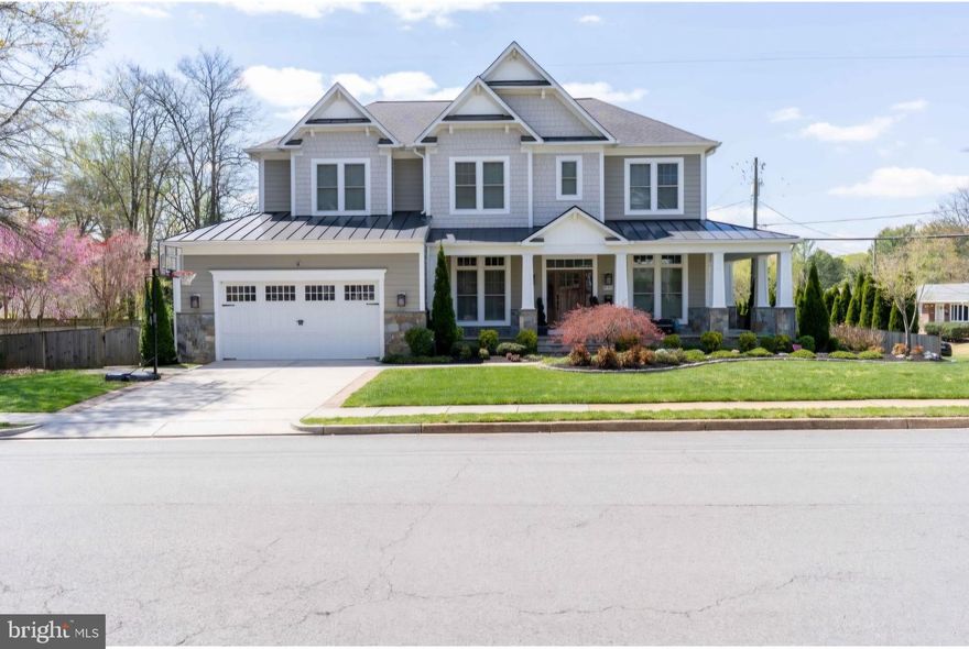 Welcome to this exquisite 6-bedroom, 5.5-bathroom craftsman residence, perfectly situated on a premium corner lot and brimming with luxurious features and thoughtful design. Built by renowned Fisher Custom Homes in 2013, this property offers over 5,000 sq ft of refined living space across three finished levels.

Step onto the charming wrap-around front porch with stone veneer, or enjoy quiet moments on the side porch with French doors. Inside, you’ll find a bright and open layout enhanced by hardwood floors throughout the main and upper levels, recessed lighting, wainscoting, crown molding, and custom trim work.

The heart of the home is an open gourmet kitchen featuring a large center island, stainless steel appliances with a hood vent, custom herringbone backsplash, and a walk-in pantry. A coffered ceiling, built-in shelving, and a gas fireplace add elegance to the living area, while the adjacent mudroom with a custom bench and garage/exterior access keeps life organized.

Main level bedroom with ensuite is perfect for guests or multigenerational living. Upstairs, the spacious primary suite is a private retreat with double doors, tray ceiling, ceiling fan, a custom island cabinet, and his-and-hers walk-in closets with barn doors. The luxurious primary bath includes frameless glass shower with overhead system, jacuzzi tub, dual vanities, linen closet, and floor-to-ceiling tile. Two bedrooms share a Jack and Jill bathroom, while plantation shutters provide privacy throughout.

The lower level is an entertainer’s dream: enjoy movie nights in your theater room with projection screen and risers, host guests at the wet bar and dry bar with wine coolers and herringbone backsplash, or relax in the bedroom with full bath. Additional features include berber carpet, walk-up stairs, a large utility/storage room, and two electrical panels.

Outside, enjoy a low-maintenance Trex deck, fenced yard, 2-car front load garage with EV charging plug, overhead storage racks, and a paver concrete driveway. Exterior includes durable Hardie board siding with an elegant gable peak design.

This home also includes a transferable membership to the Vienna Aquatic Club — offering exclusive access to swimming, recreation, and community at one of the area’s most sought-after swim clubs without having to be on the wait list! 

This exceptional home offers both luxury and function in a prime location. Nearby attractions include Route 66, the Vienna Metro Line, Pan Am Shopping Center, Mosaic District, Maple Avenue Shops, Vienna Plaza, Vienna Shopping Center, Nottoway Park, trails, and more. Schedule your private showing today!