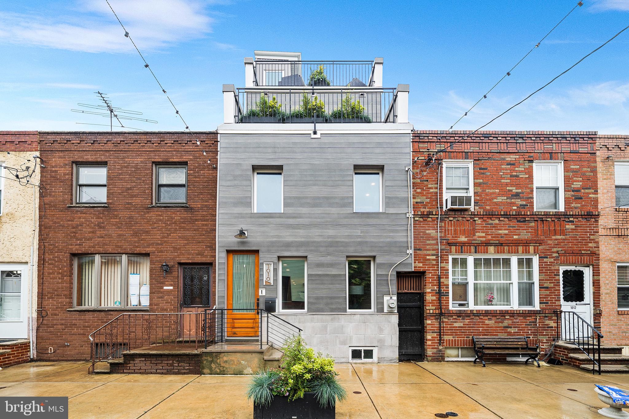Welcome to 1010 Cross St, a 3-Story, 3 Bed, 2.5 Bath, beauty, located on arguably the best block in Passyunk Square. Living here, you’re just steps away from the Singing Fountain, and Passyunk’s best restaurants & shops. This home has roughly 5 Years Left on the Tax Abatement*! Step inside the home and you will find an open floor plan with wide plank white oak flooring that run throughout the above grade levels of the home. A contemporary fireplace and mantle centers your living room, with TV hookups above the mantle. Just past the living room is a powder room for convenience. Towards the back of the first floor you will find a sleek, contemporary kitchen, outfitted with two-tone, flat panel cabinets, stainless steel appliances and quartz countertops that waterfall off the peninsula that provides seating for dining & entertaining. A double glass sliding door leads out to the rear yard and provides ample space for your warm weather get togethers. Upstairs you will find 2 bedrooms, each with great closet space, a large, stylish full bathroom and your laundry. Head up the stairs to the 3rd floor and you will find the Primary Suite. The Primary is complete with a large bedroom that provides city skyline views off of its private deck, a walk-in closet and a huge, modern, 4-piece bathroom with a free standing soaking tub. Above the Primary is a full roof deck with unobstructed 360 degree views of Philadelphia, river to river. Downstairs you will find a fully finished basement with space that can flex for many different uses as well as a storage closet. With a “WalkScore” of “98”, this is your chance to live in a stunning home and steps from some of the city’s hottest spots, including; Palizzi Social Club, El Chingon, Rival Bros., Suprette, Fountain Porter, Milk Jawn, Townsend and a lot more. Only a few blocks from the Broad Street Line Subway for easy access to the Stadiums, Center City & beyond!