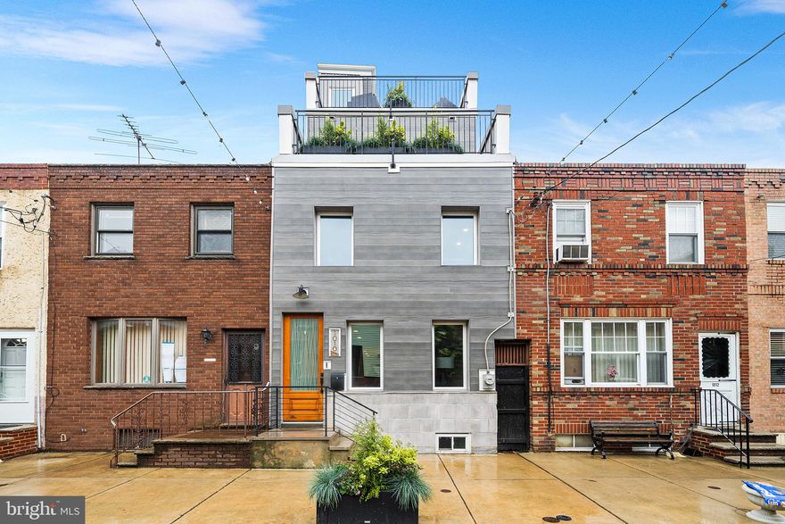 Welcome to 1010 Cross St, a 3-Story, 3 Bed, 2.5 Bath, beauty, located on arguably the best block in Passyunk Square. Living here, you’re just steps away from the Singing Fountain, and Passyunk’s   best restaurants & shops. This home has roughly 5 Years Left on the Tax Abatement*! Step inside the home and you will find an open floor plan with wide plank white oak flooring that run throughout the above grade levels of the home. A contemporary fireplace and mantle centers your living room, with TV hookups above the mantle. Just past the living room is a powder room for convenience. Towards the back of the first floor you will find a sleek, contemporary kitchen, outfitted with two-tone, flat panel cabinets, stainless steel appliances and quartz countertops that waterfall off the peninsula that provides seating for dining & entertaining. A double glass sliding door leads out to the rear yard and provides ample space for your warm weather get togethers. Upstairs you will find 2 bedrooms, each with great closet space, a large, stylish full bathroom and your laundry. Head up the stairs to the 3rd floor and you will find the Primary Suite. The Primary is complete with a large bedroom that provides city skyline views off of its private deck, a walk-in closet and a huge, modern, 4-piece bathroom with a free standing soaking tub. Above the Primary is a full roof deck with unobstructed 360 degree views of Philadelphia, river to river. Downstairs you will find a fully finished basement with space that can flex for many different uses as well as a storage closet. With a “WalkScore” of “98”, this is your chance to live in a stunning home and steps from some of the city’s hottest spots, including; Palizzi Social Club, El Chingon, Rival Bros., Suprette, Fountain Porter, Milk Jawn, Townsend and a lot more. Only a few blocks from the Broad Street Line Subway for easy access to the Stadiums, Center City & beyond!