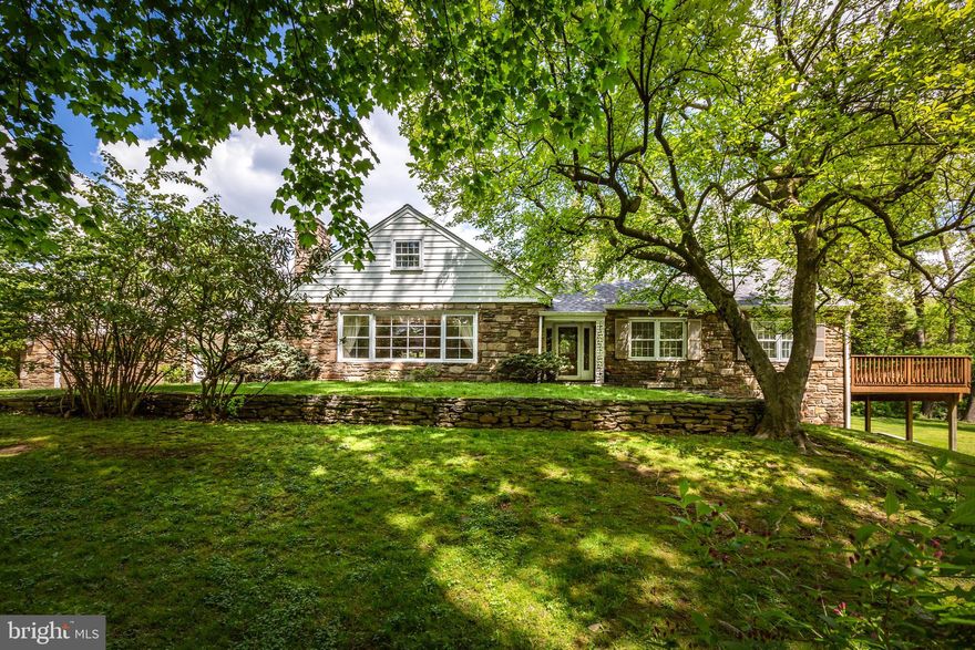 Envision the possibilities in this attractive stone colonial on a lush, 2+ acre lot! Nestled on a private cul-de-sac street, this home represents a quality investment in an idyllic setting. Special features include wood floors, a main floor primary suite, charming built-ins and woodwork, a lovely deck with wooded views, and a two-car attached garage. The welcoming foyer with coat closet opens into the sunny living room with a large front window, fireplace, and built-ins. There is also a side door that leads conveniently out to the breezeway/patio with access to the two-car garage. The formal dining room flows easily into the kitchen with wood cabinets and a center island. Glass sliders in the breakfast area lead out to another patio with attractive brick pavers. A spacious den provides additional living space for the household to enjoy, and a private office would make an ideal work-from-home space. The den, office and main bedroom all feature glass sliders to the rear deck with lovely wooded views. The main bedroom suite also features an en suite bathroom. Upstairs you will find two additional bedrooms and a full bathroom. The walk-out lower level and two-car garage provide plentiful storage space. This great location in the excellent Lower Merion School District is just minutes from Belmont Hills Pool and Library, Cynwyd Trail, Center City, the Blue Route, and the Schuylkill River. You are also close to the parks, movie theaters, restaurants, and shopping that Bala Cynwyd, Manayunk, and Narberth offer. Take advantage of this exceptional opportunity to make this well-maintained and cherished home your own! **Also available as Land - MLS# PAMC2073166**