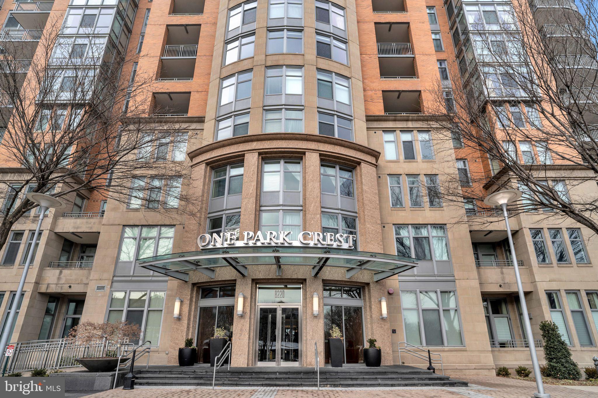 Situated at the heart of Tysons Corner, this Penthouse level unit is impeccably renovated, professionally designed, and furnished by world renowned London-based designer, Katharine Pooley. This incredible residence consists of 2253 square feet and glorious views of the Washington Cathedral and Northern Virginia. Unit consists of an oversized living room, dining room, three bedrooms, laundry room, a spectacular kitchen, 4 bathrooms, and 3 spectacular balconies. This light flooded home has additional impressive special features successfully created by a perfectionist whose goal to create a luxury “one of a kind” living experience was met.
The stunning wall coverings, the airy 10 foot ceilings, exquisite and elegant master bedroom headboard, uniquely procured Italian chandeliers, sophisticated British joinery and cabinets in the living room flown and installed from London, along with the marvelous sunrise and sunset from every room greets you upon entering the foyer. The entry foyer includes a full bathroom and a large coat closet lined with custom built-ins and shelves. The living room with its direct Tysons views leads to a kitchen with new marble countertops and Viking appliance that is adjacent to a custom built breakfast lounge area. The island kitchen is perfect for entertainment. In addition, there is a full laundry with brand new washer/dryer. Every closet includes custom built-ins and every bathroom is designed with unique wall coverings, mirrors, and lighting.
Being on the Penthouse level, the unit offers a double door entry, in addition to two parking spaces, and a storage unit. This fully furnished, turn-key property underwent a $1 million renovation and redesign.
One Park Crest offers 24-hour concierge. Amenities include a rooftop pool, renovated party room with panoramic views, fitness center, library, and 2 guest rooms for short term rental.