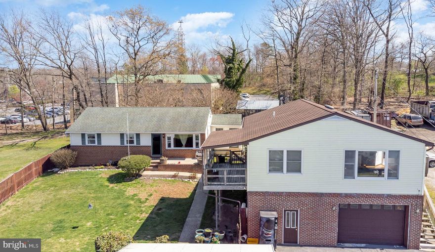 In the quiet and welcoming town of Odenton, Maryland stands a charming rancher that exudes both warmth and practicality. With its four bedrooms, two bathrooms, and unique potential for in-law quarters, it is a home that offers versatility and endless possibilities.
As you approach the property, you can’t help but notice the sturdy brick front that gives the rancher a timeless appeal. The neatly fenced yard encircles the dwelling, providing a safe haven for playing sports and pets to roam freely. And to your delight, there, at the back of the property, is an inviting above-ground pool—a perfect spot for lazy summer days and lively gatherings.
Upon entering the rancher, you are greeted by an open and inviting atmosphere. Sunlight streams through the large windows, illuminating the freshly painted walls that add a touch of modernity to the home's classic design. The main level boasts a comfortable living area, a well-appointed kitchen, three spacious bedrooms, sun /laundry room and a full bath.
 It's lower level, is where a world of possibilities await. Descending the stairs, you will discover a hidden gem—a full kitchen, a generously-sized bedroom, and a full bathroom with ample closets. Because of its outside entrance, the lower level could easily be transformed into a self-contained living space, perfect for accommodating extended family, visiting friends, or even generating rental income. The option to divide the rancher into in-law quarters opens up a world of opportunities for the homeowner.
However, what truly sets this homestead apart is the spacious three-car garage with an apartment above. The apartment features a fully equipped kitchen, living room, dining area, laundry center, three bedrooms and two bathrooms. It provides additional living space and added value to the already enticing package. It also boasts its own deck where you enjoy your early morning coffee or favorite beverage on a hot day. The apartment is on its own electric meter.  The apartment is a haven for guests or a potential source of rental income for the savvy homeowner.
Outside, the flag-shaped lot offers ample space for outdoor activities and endless entertainment options. The fenced yard ensures privacy and security, allowing you to create memories and host gatherings without worry. The garage, fully fitted with electricity and plumbing, is a car enthusiast's dream, offering a space for projects and hobbies.
And let's not forget about the location, situated in the heart of Odenton, this homestead is conveniently close to Fort Meade, schools, shopping centers, and various amenities. Commuting to neighboring towns or the bustling city of Baltimore is a breeze, thanks to its strategic positioning near major highways and transportation hubs.