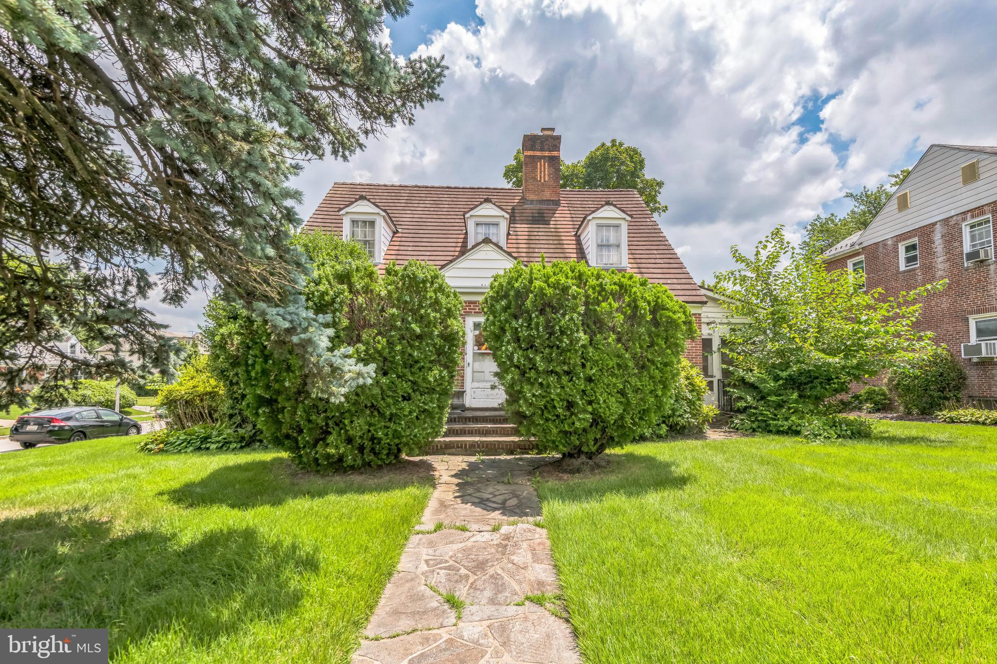 Classic brick charm meets unlimited potential in Baltimore. Step into timeless curb appeal with this 2-story red brick beauty, ideally located near top-rated schools and everyday conveniences. Featuring 3 large bedrooms and 2 full bathrooms, this home is packed with vintage charm and waiting for your modern touch.
The main living room welcomes you with a statement stone fireplace, ornate ceiling detail, and rich natural light. The adjoining formal sitting area is dripping with old-world elegance, from the crystal chandeliers to the arched entryways—offering a glimpse into the home’s storied past. The kitchen, while retro in style, offers great bones and layout potential for a total remodel or restoration.
Outdoors, the screened-in porch offers a peaceful retreat surrounded by mature landscaping and a lush green lawn. The home sits proudly on a corner lot, complete with a stone walkway and classic dormer windows, exuding classic 1940s Baltimore architecture.
While this home needs TLC and thoughtful renovation, the solid structure and undeniable character make it a dream opportunity for renovators, investors, or families looking to customize a forever home in a well-established neighborhood.