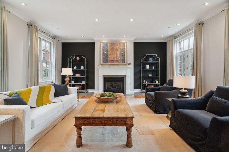 Secluded, Grand urban Estate hidden away in the Spring Garden historic section of the Art Museum neighborhood. This 4 bedroom, 3 1/2 bath modern townhome with 2 car Garage parking is set back from North street, accessed through a gated garden entrance, and backs onto private Melon street. Over 4500sf of considered living space was designed by esteemed local architect Cope-Linder and exudes grandeur and sophistication in every detail.  The home has a flagstone terraced front garden surrounded by raised planting beds and is walled for privacy. A covered portico entrance leads to the main foyer where solid oak stairs bring you to the second level "piano nobile" main living space. 10’ ceilings with crown moulding emphasize the large scale while oversized windows flood the home with sunshine. The long side of this extra-wide lot is oriented with north and south exposures for incredible light throughout the day. A clean and contemporary design throughout sets the home apart from its surroundings. The state-of-the-art chef's kitchen is adorned with solid cherry cabinetry, stone counters, and is outfitted with a Viking 6-burner stove and Monogram built-in refrigeration. Wide plank solid oak floors continue throughtout the house and lead you to the spacious living room adorned with crown molding and a gas fireplace centering the room against a limestone hearth. French doors with Juliette balconies invite natural light and fresh air, while a terrace over the entrance provides a serene outdoor retreat. A fully outfitted wetbar or butlers pantry serves the dining room while a cozy den is tucked away past the kitchen. Ascend the stairs to the third level housing the expansive primary bath featuring a double vanity dressing area, separate wetroom with a glass-enclosed shower and jacuzzi tub, and a walk-in closet; epitomizing spa-like comfort and convenience. The primary bedroom is flanked by oversized windows, high ceilings and a gas fireplace add to the intimate ambiance. Two more bedrooms are joined as a suite and a hall bath and laundry station complete this floor. Ascend to the top floor pilot house with full wet bar opening to a huge roofdeck with limitless views of the Center City skyline. Additional amenities include a main-level bedroom suite with a full bath and kitchenette, a large den with double French doors that connects to the flagstone terrace, and a wood paneled elevator providing easy access to all levels. The lower level finished basement provides excellent casual entertaining space or workout area as well as the home’s mechanical systems. Dual zone HVAC, central vacuum and a built in sound system round out the conveniences of the residence. With its prime location near from the Spring Gardens community garden, Roberto Clemente playground and just steps to the vibrant commercial Fairmount Avenue corridor featuring Tela Cafe, Bar Hygge, Fare Restaurant, Jack’s firehouse and so much more.  There is easy access to the Barnes, the Philadelphia Art Museum, the downtown Center City core, and incredible cultural institutions along the Benjamin Franklin Parkway this home is close to everything that makes city living so incredible; an unparalleled lifestyle of luxury and convenience.  Come see this exceptional residence today!