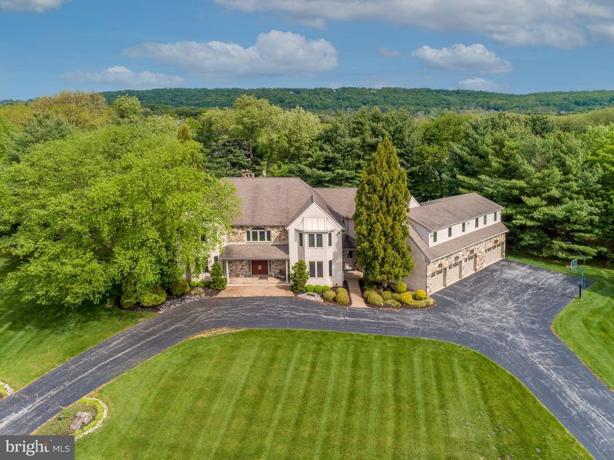 Magnificent, Anne Capron designed home is truly one of a kind. This  2-story Colonial boasts 5 bedrooms, 6 full baths, 3 powder rms and is on the market for the first time. Like to Swim?  Watch movies? This home offers it all as the original owners have maintained and updated it during their ownership. In 2005, a Peter Batchelor designed addition was created that sets this home apart from any other. The addition features a fabulous dedicated room featuring an Endless pool, heated tile flooring, its own heating system, kitchenette, amazing bathroom equipped with sauna & oversized stall shower. Additional bays were added so the garage can hold 4 cars. Go upstairs to the media room to enjoy movies (dumb waiter transports luggage) or go downstairs to enjoy the addition’s finished lower level. The main house built in 1997 has 9’ ceilings, HW floors, central vac, recessed lights, the Primary Bath was updated in 2016 and an updated kitchen. There are 4 zones, propane heat (500 gln tank), 1 fireplace & the garage has oversized commercially motorized wooden garage doors. Drive up to the circular driveway and enter the home’s foyer with a soaring ceiling, HW’s and turned staircase to the 2nd level. A formal LR boasts recessed lighting, casement windows & pocket doors leading into a large family room. This room features a gorgeous built-in entertainment center, stone surround fireplace & sliders to the large rear deck. Cook or bake up a storm in this eat-in gourmet kitchen featuring a built-in sideboard, ceramic tile floors, large Island, granite tops, tile backsplash, wood cabinets, another set of sliders to rear deck, SS faucet, garbage disposal, SS Bosch DW, Wolf 5 burner electric cook top, SS GE Profile Microwave, SS Double Wall Oven, SS Sub-zero refrigerator, bay window above sink, walk-in Panty with customized shelving & built-in desk. The formal DR features built-ins to store china, recessed lights and hardwoods. Stay on this level to the addition, pass a 2nd powder room, a laundry room with cabinets & storage closet and enter the dedicated pool room. This fabulous room has a heated tile floor, 3 walls of windows & another set of sliders to rear deck. After swimming laps, enjoy a snack in the kitchenette equipped with granite tops, 42” wooden cabinets, 2 U-line refrigerator drawers, sink, Bosch DW & garbage disposal. From here the pool’s full bath is fantastic with sauna & stall shower. A large skylight allows for tons of natural light. Leave this area to go downstairs to the addition’s finished lower level used as a game room or to the 2nd level where the media room is located. When you get to the top floor of the house, enjoy 5 bedrooms, 4 full baths and mirrored gym. The Primary BR has 2 walk-in his and her closets, a mini-spilt for supplemental a/c and a recently renovated Primary Bath (2016). This bathroom boasts radiant floor heat, quartz top double vanity, porcelain tile flooring, private loo closet, standing tub and large walk-in shower with several shower heads. There is a hot water circulator connected to the primary bath for quick hot water delivery. While in the addition’s lower level, you can find another full bath, 2 unfinished areas- 1 dedicated to the pool equipment and the other dedicated to the systems- all top of the line and regularly maintained. From this unfinished area one can enter the finished lower level of the main house. This carpeted space is huge as it’s the footprint of the original house and features another powder room, a bar with a refrigerator, two closets for the systems and a staircase to the kitchen of the original house. There are multiple heaters, two generators, 2 water heaters (1 new),  alarm & underground sprinkler systems. Great storage in walk-up floored attic w/ 2 fans. Approxicosts are: 2005 addition $400K; MBA $150K; Kitchen $100K. Close to major arteries, shopping & restaurants. Listing Agent to meet appts. Sq ft in PR wrong,  estimate is 6,763.