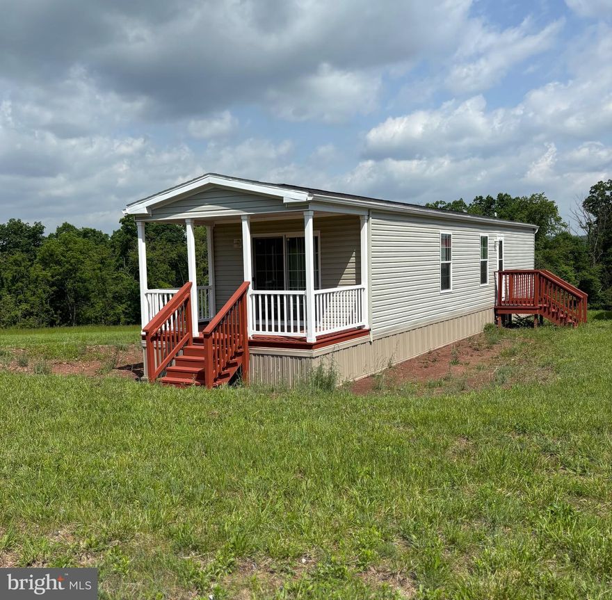Welcome to a little slice of Wild, Wonderful West Virginia!  The owner envisioned a place to relax and enjoy the serenity of life in the country and they got it.  Situated along a state maintained road, this 2 acre parcel has a single wide mobile home that has only been used a couple of times. It even still smells like a new home! In fact, the stainless appliances still have some of the protective plastic from the manufacturer. The living room boasts a "stacked stone" wall and built in corner cabin with shelves to display your photos and collectables.  The dining room also has built in shelving.  But one of the most enjoyable features is the covered deck off of the bedroom...a perfect place to sit and watch the world pass by (or the wildlife). To add to the desirability, there is a recently installed, new barn style shed to store all your outdoor toys and equipment.