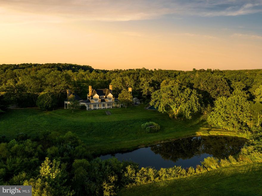 Live authentically. Welcome to a transcendent architectural marvel, an invitation to experience the extraordinary. In the heart of the serene Worthington Valley, behold 'Sweetwater Farm.' This exquisite estate, masterfully sited and designed by the renowned Bernard Wharton of Shope Reno Wharton in Greenwich, CT, is a symphony of style and unparalleled natural beauty.
 
As you embark on your journey, a long and private drive unfolds before you, leading you through a lush landscape that hints at the majesty awaiting your arrival. Along this enchanting route, your senses are awakened by the first glimpse of a pristine pond, a tranquil oasis that beckons you to pause and savor the moment—a prelude to what lies ahead.
 
Upon reaching your destination, 'Sweetwater Farm' unveils itself with an artful sense of placement, thoughtfully  designed to harmonize with its surroundings. Bernard Wharton's visionary touch becomes evident as you step inside, with strong architectural elements and outdoor spaces designed for maximum enjoyment crafted to frame the breathtaking vistas of the sprawling countryside and the glistening idyllic pond.
 
Approaching the front of the house, you are greeted by the enchanting sight of clematis adorning its facade, their white blooms creating visual poetry that sets the tone for the sensory journey that awaits. A tastefully designed rectangular pool seamlessly integrates with the landscape, offering a tranquil oasis to refresh and rejuvenate. Nearby, a glorious wildflower path invites you to immerse yourself in the vibrant colors of nature. 

The heart of this residence is a magnificent great room serving as a captivating focal point. It is flanked by dueling fireplaces that evoke warmth and intimacy. A wall of glass provides for a light drenched inviting glow throughout. Here, 'Sweetwater Farm' takes on the charm of a whimsical English garden party, inviting you to revel in the joy of living amidst nature's splendors.

Each faced of this extraordinary estate offers captivating layers of vistas, providing an ever-changing canvas that reflects the beauty of the seasons and the wildlife that graces your idyllic setting. Living here feels like residing within a painting, a tranquil retreat that transports you to a world of serene beauty while being nestled in the heart of Worthington Valley. Privacy abounds.
 
For those with a love for cultivation, 'Sweetwater' offers a greenhouse and a charming outbuilding. There is ample space to nurture your equestrian pursuits, nature walks, and birdwatching. Every suite within your home has been thoughtfully designed for ergonomic functionality, maintaining a harmonious balance, framed views, and exquisite aesthetics.
 
And when you seek respite from the outside world, a peaceful screened-in porch awaits, a sanctuary where you can bask in the splendor of the landscape while being sheltered from the elements.
 
'Sweetwater Farm' is a lifestyle experience that seamlessly melds enduring materials, architecture that reaches into the landscape on a setting that nourishes the soul.  Welcome home. This estate is available separately on 24.47 acres or as a package with an additional 11.89 acre lot for a total 36.36 acres for $2,926,000 see MLS# -  MDBC2078432. Cultivate your existence. Please book your appointment now. In the event the active date changes, you will be notified. The art of uniting human and home. Please do not visit or drive down driveway without an appointment.