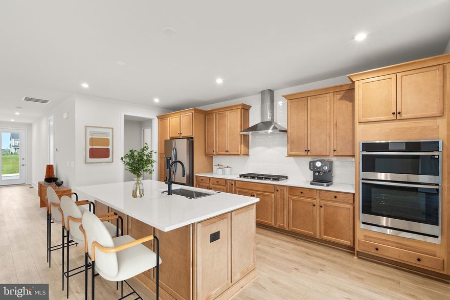 Step into the Sierra 39-F2 – Homesite 1037 at Hiatt Pointe (55+)—a two-car, front-load garageSINGLE FAMILY home with three bedrooms and three full bathrooms will be ready IMMEDIATELY. Designed for ease and everyday function, this floorplan is as innovative as it stylish! Enter through the inviting front porch and be immediately welcomed by 9’ ceilings on both levels, oak main stairs, and expertly selected finishes. The heart-of-the-home kitchen is complete with light brown cabinetry, white quartz countertops, an oversized island with a built-in trash can, and a walk-in pantry with solid-shelving. In the kitchen, enjoy Samsung® stainless steel appliances including a five-burner cooktop with chimney hood, single wall oven, refrigerator, microwave, and dishwasher.  Cozy up in the great room with an electric fireplace and extend your living outdoors a 20’ x 12’ walkout deck. The main level primary suite includes a spa-inspired bathroom with dual vanities, light brown cabinets, white quartz countertops, a roll-in frameless shower with white floor-to-ceiling tile, and elongated comfort-height toilets. The walkout finished basement offers a spacious rec area, an additional full bathroom, and a bedroom. The two-car finished garage with electric opener and exterior keypad adds daily convenience and extra storage. Built for comfort and sustainability, this home features smart home technology and energy-saving innovations, including a Home Automation Package with IQ Panel 4, Ecobee® smart programmable thermostat, energy-efficient insulation techniques, social panel ready, and more. Being a new build, your home is constructed to the highest energy efficiency standards, includes post-settlement warranty, and has never been lived in before! Don't miss out on this opportunity to own a home in an Active Adult community in Winchester—get in contact with a Van Metre Sales Advisor today for more information! Take advantage of closing cost assistance by choosing Intercoastal Mortgage and Walker Title. ----- Discover Hiatt Pointe at Snowden Bridge, a gated active adult community designed for 55+ living, where every day brings new opportunities to connect, unwind, and thrive. Start your morning with a yoga session or workout in the fitness center before joining friends for a game of pickleball or billiards. In the afternoon, lounge by the outdoor pool and hot tub, then gather around the gas fire table as the sun sets. The clubhouse serves as the heart of the community, offering inviting spaces for social events, group activities, and quiet relaxation. Outdoor kitchens and scenic patio areas set the stage for effortless entertaining, while a low-maintenance lifestyle ensures more time for what matters most. With easy access to Route 7, I-81, and I-66, Hiatt Pointe offers the perfect blend of resort-style amenities and a welcoming, connected community.----- *Other homes sites and delivery dates may be available. Pricing, offers, and availability are subject to change without notice. Images, renderings, and site plans are for illustrative purposes only and may not reflect actual homes or features. Some images may depict interior designs created in collaboration with AI. Additional Terms and Conditions may apply. Please see a Van Metre Sales Advisor for details.