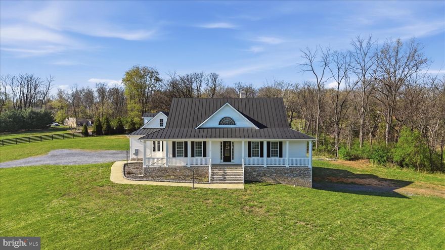 Beautifully designed home situated on 5 acres, offering space and comfort! This spacious property features 4 bedrooms and 4 full bathrooms, including 2 main-level bedrooms with walk-in closets for added convenience. Step inside to find hardwood flooring throughout the main living areas, a stunning 2-story stone fireplace as the centerpiece of the home, and a well-appointed kitchen with granite countertops, an island with an additional sink, and breakfast nook. A formal dining room adds elegance for hosting gatherings. The upper level features 2 bedrooms with a full bath that leads into one of the bedrooms. The upstairs hallway has a banister and overlooks the first floor. Upstairs bedrooms have casement windows. The home also offers a full unfinished basement complete with a full bath and garage with door opener. Basement is already framed and ready for your finishing touches-perfect for expanding living space or creating an in-law suite. A 2-car attached garage on the main level.  Step inside from the garage and find an oak stairway leading to an unfinished bonus room above providing even more opportunity for customization. Enjoy the outdoors from the charming L-shaped front porch or relax on the back deck overlooking a partially fenced yard. Additional features include a durable metal roof and there is a concrete pad and hookup for outdoor woodstove. This property combines peaceful country living with room to grow-don't miss the chance to make it your own!