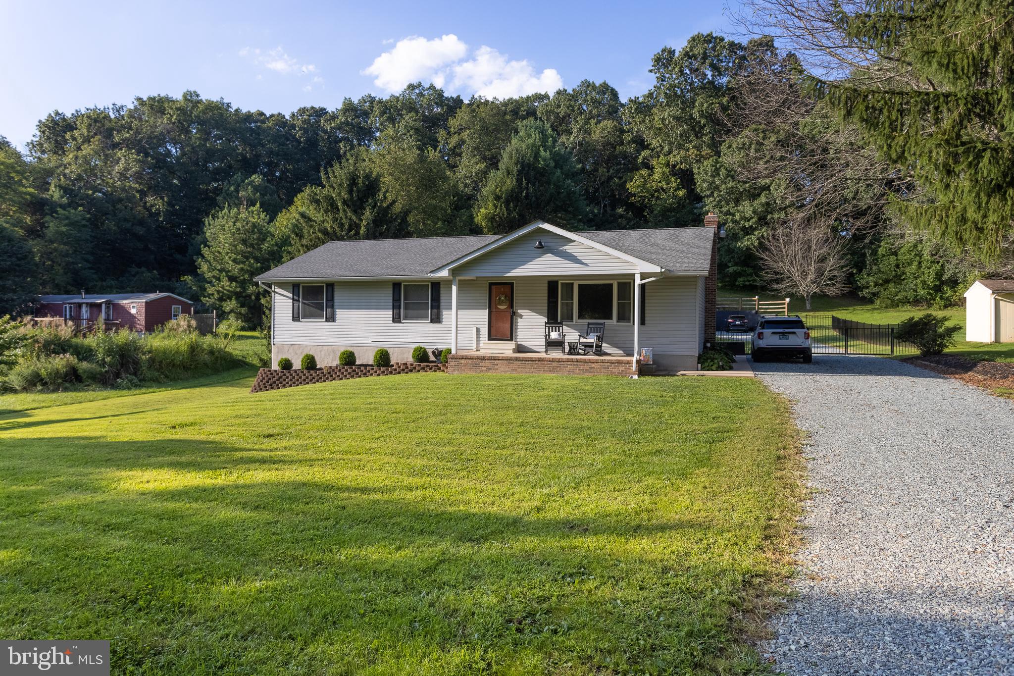 Charming 3 Bedroom Rancher Near Rock State Park! Nestled on a spacious 1.09-acre lot, this beautifully maintained ranch-style home offers peace, privacy, and no HOA restrictions. Enjoy your morning coffee on the covered front porch, or entertain guests on the wood rear deck overlooking a large, fenced backyard—perfect for pets, play, or gardening. Inside, you’ll find an updated kitchen featuring sleek silver steel appliances, modern finishes, and an country feel. The partly finished basement offers bonus living space—ideal for a rec room, home office, or gym. A true standout feature is the massive 3-car detached garage, offering tons of space for vehicles, hobbies, or a workshop. All this just minutes from the scenic beauty of Rock State Park. Don’t miss your chance to own this gem!