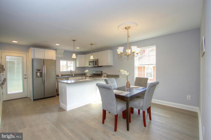 Beautiful Modern Style Renovation, this is a must see! First floor features a traditional floor plan w/living room leading to dining room that flows in to kitchen that has all the bells & whistles, granite counters, stainless steel appliances, & wood floors. Also has 1st floor master suite. Fully finished basement with 4th bedroom & full bath. Stone shower floors w/ ceramic tile.Home Warranty