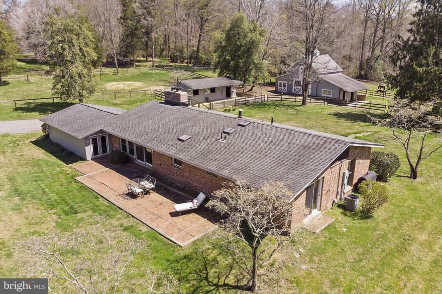 RARE FIND with this COMBINED property listing of 11713 Chapel Road (with house and barns) AND 11707 Chapel Road (5.09 acre parcel used as pasture but zoned for residential building, 1DU/5AC), totaling an expansive 10.62 acres OF EXCEPTIONAL LAND. Perfect for horse lovers and those seeking a tranquil retreat. This incredible Property boasts a charming Mid-Century Modern house, 2 barns with 5 large horse stalls, offering you the best of farm and residential property. The 3 bedroom, den and 2 full bath, brick home features striking architecture with oversized, high-quality walls of windows (2000) that frame breathtaking pastoral views. Inside, enjoy spacious living and dining rooms with cathedral ceilings and exposed beams, a double-sided fireplace, built-in bookshelves, and a  slate floor living room. The interior also has hardwood floors in the kitchen and dining areas, a country kitchen with cherry cabinets, stainless steel appliances, a pantry, fireplace, and ample space for a kitchen table, Skylights add natural light and 6 ceiling fans add ambiance. The bedrooms have vaulted exposed beam ceilings and the baths are updated. A new roof was installed in 2009.
The property includes two well-appointed barns, with electric and water access, and the larger barn built in 2000. Complementing the barns are gorgeous fenced pastures, automatic waterers for horses, a hay loft, and a tack room/storage area. Set in a peaceful and idyllic location just minutes from everyday conveniences, this estate offers quick access to Fairfax County Parkway, Rt 123, shopping, dining, and the charming town of Clifton. This unique gem combines comfort, functionality, and a serene lifestyle, making it a perfect retreat for those who appreciate a peaceful oasis and equestrian excellence.